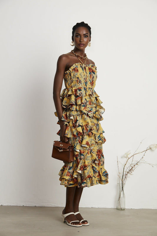 Floral print midi dress with tiered ruffles named Apolline on a plain background