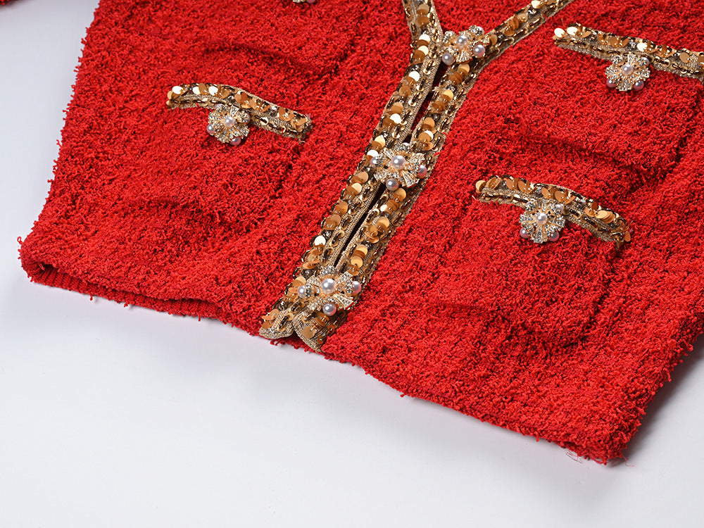 Elegant red tweed jacket with gold embellishments paired with a matching midi skirt, ideal for formal occasions