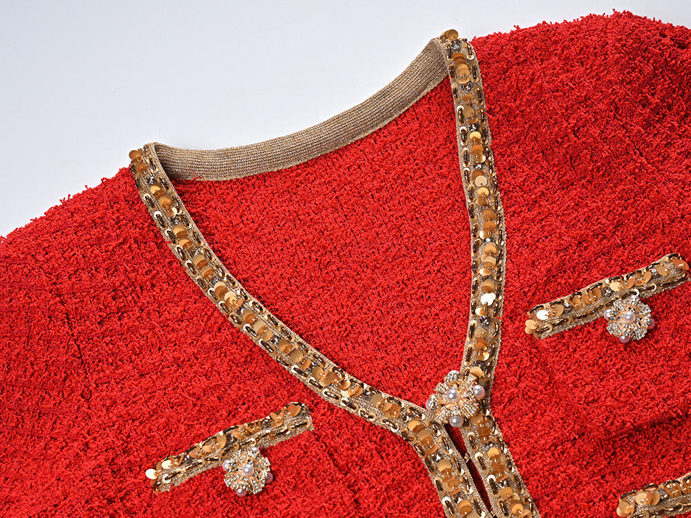 Elegant red tweed jacket with gold embellishments paired with a matching midi skirt, ideal for formal occasions