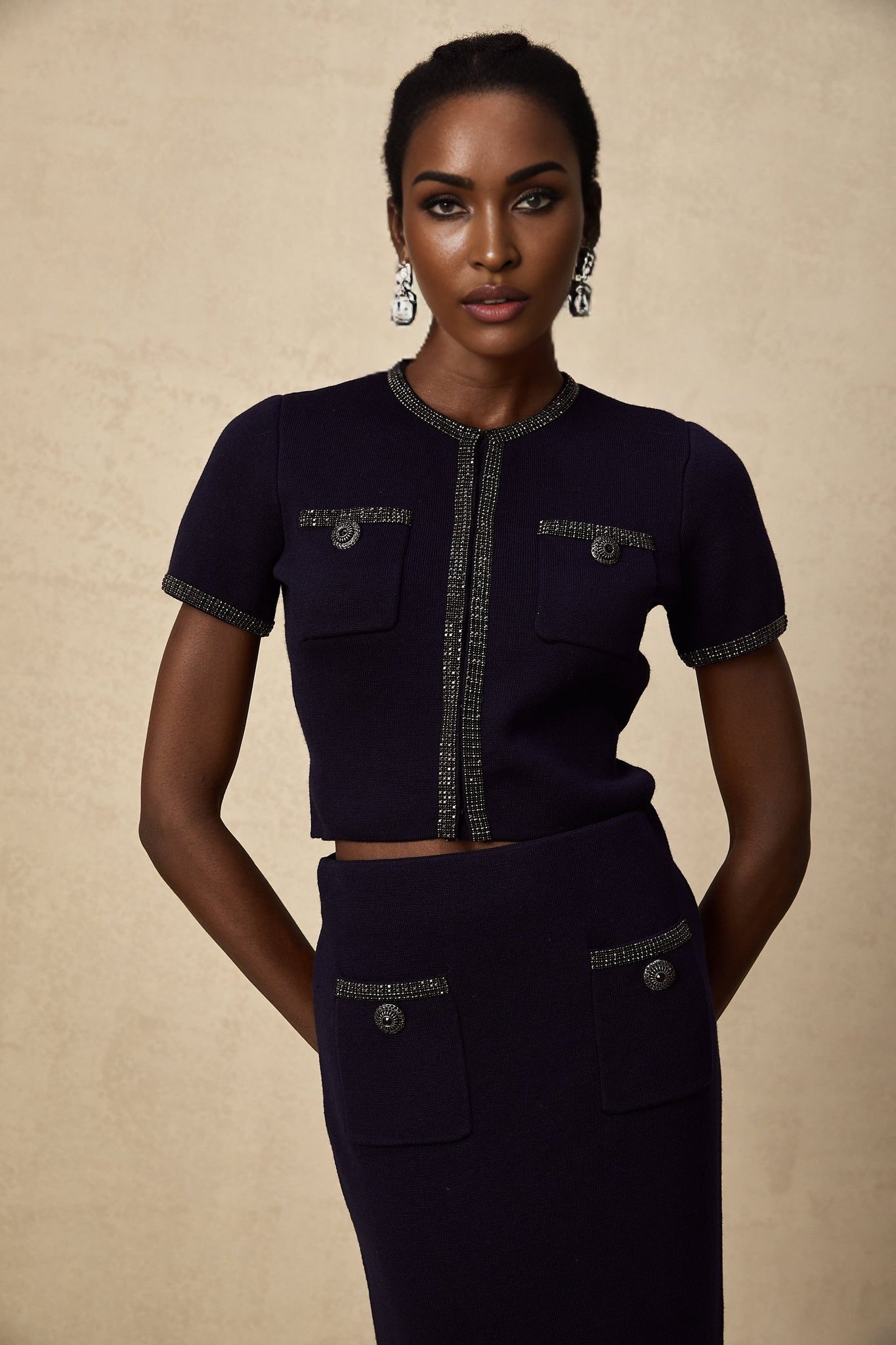 Heres a simple alt text for the product image based on the given title
Woman wearing matching ribbed knit top and skirt set with embellishments in Aida style