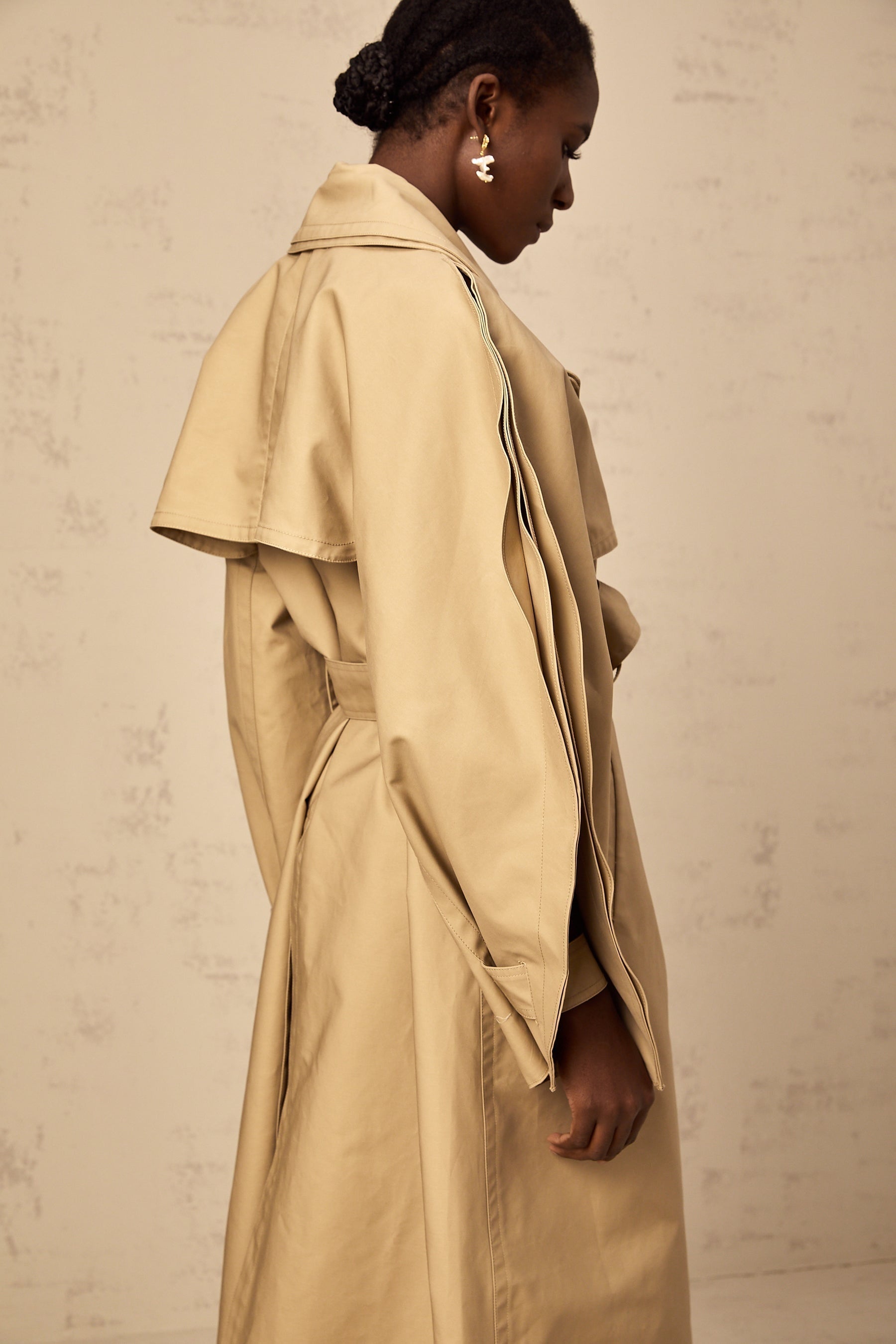 Jaden khaki trench coat with curved sleeves on a mannequin or model showing the front view