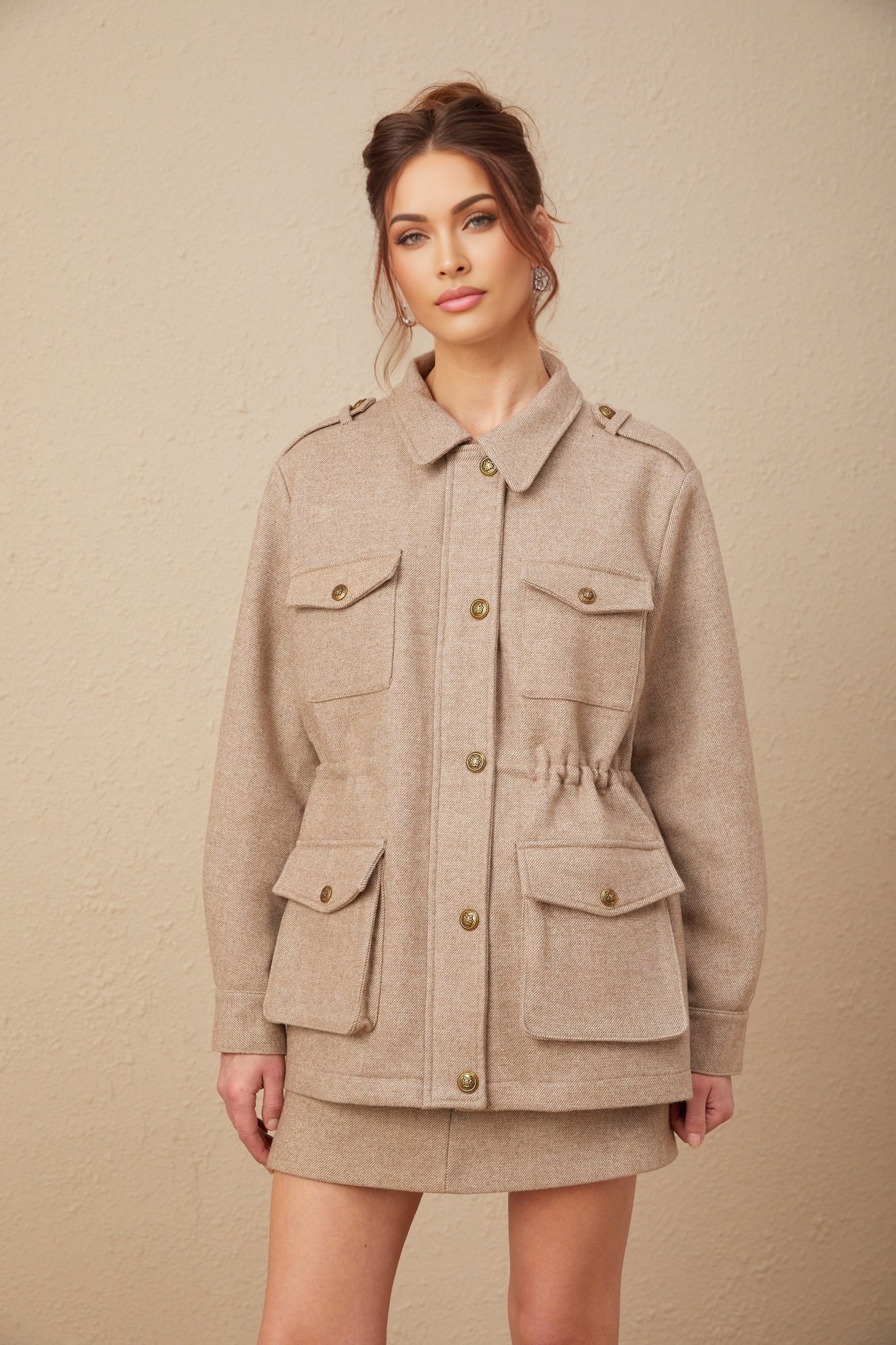 Khaki wool twill jacket and matching culottes set by Clarisse on a plain background