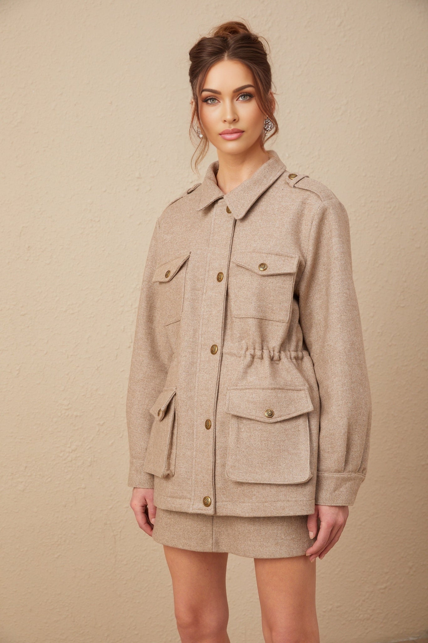 Khaki wool twill jacket and matching culottes set by Clarisse worn by model against plain background