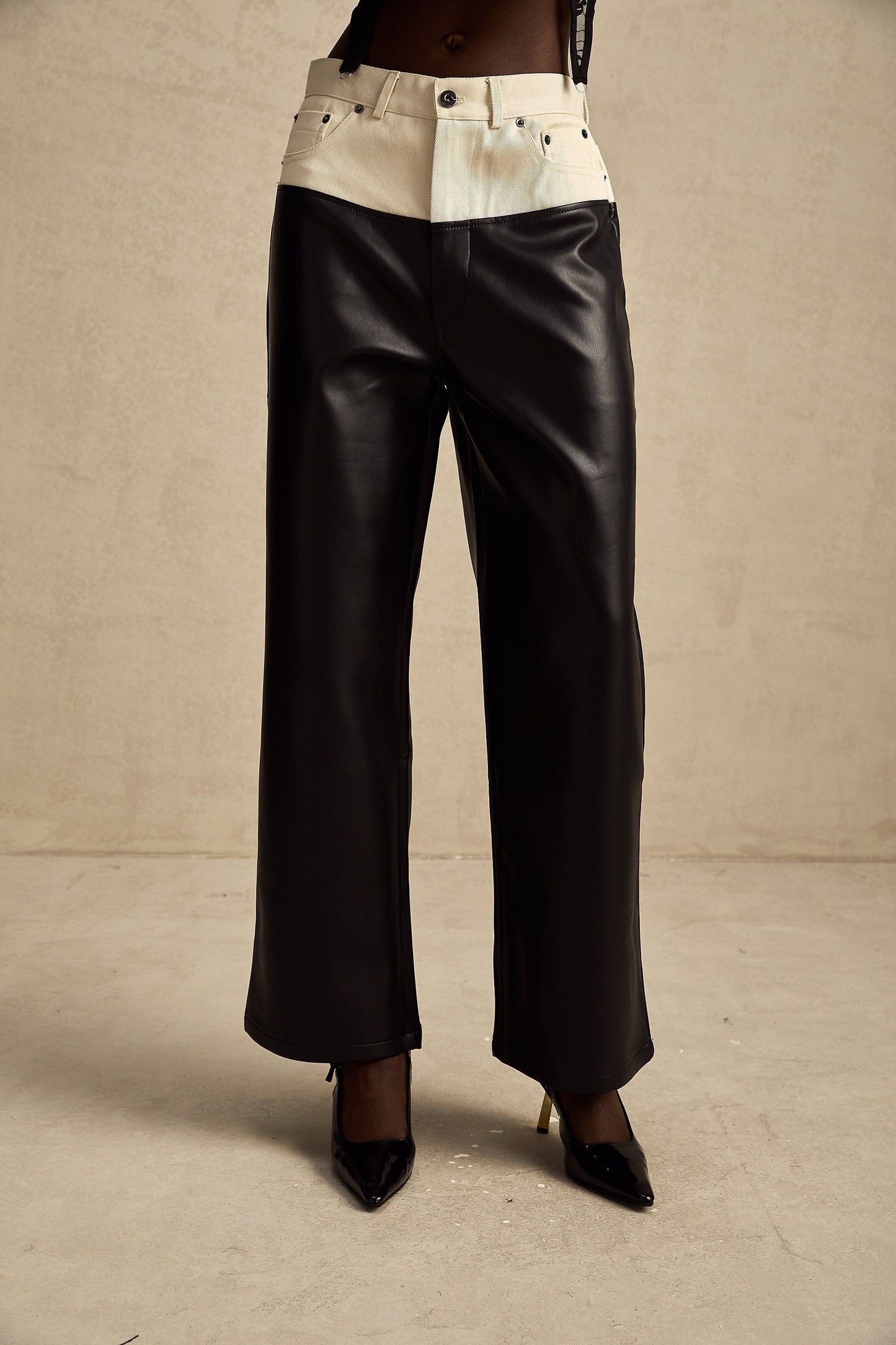 Leather trousers with contrasting color panels featuring a design by Clotilde