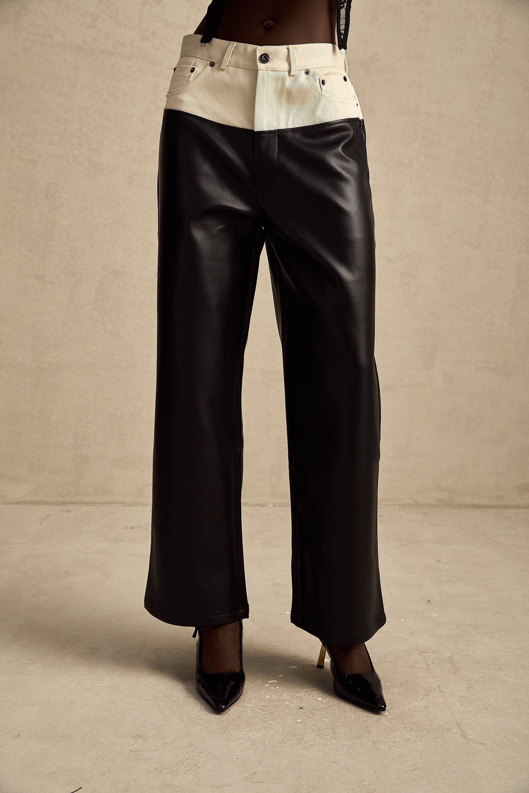 Leather trousers with contrasting color panels featuring a design by Clotilde
