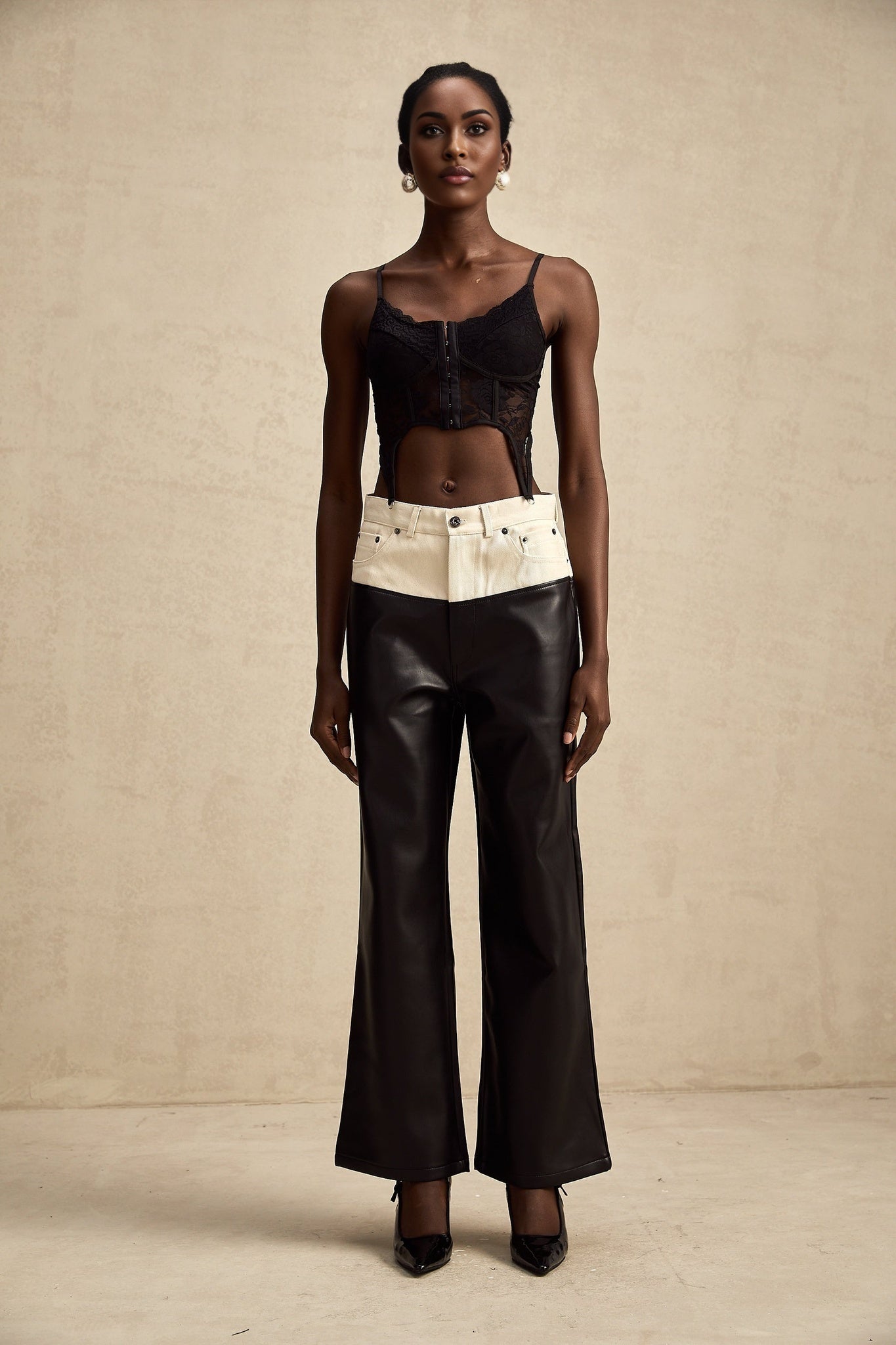 Leather trousers with contrasting color panels featuring a sleek design and fitted silhouette