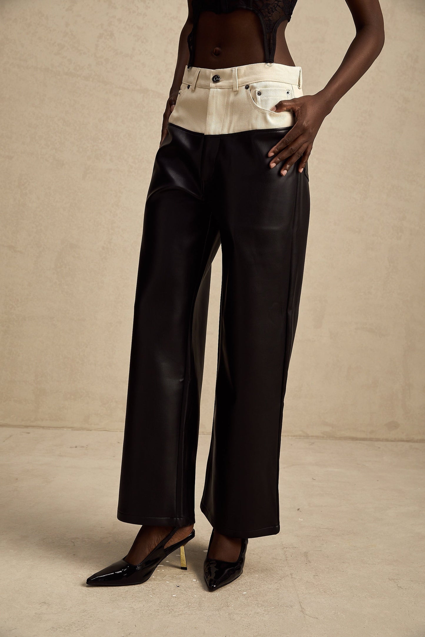Leather trousers with contrasting color panels featuring a slim fit design