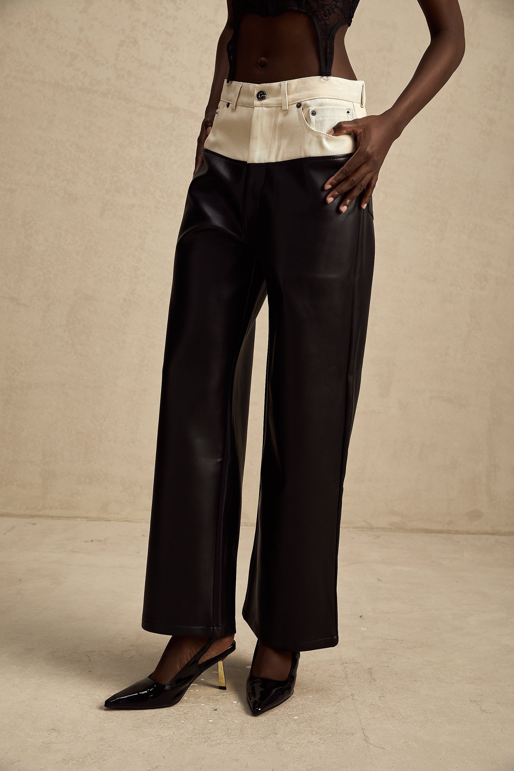 Leather trousers with contrasting color panels featuring a slim fit design