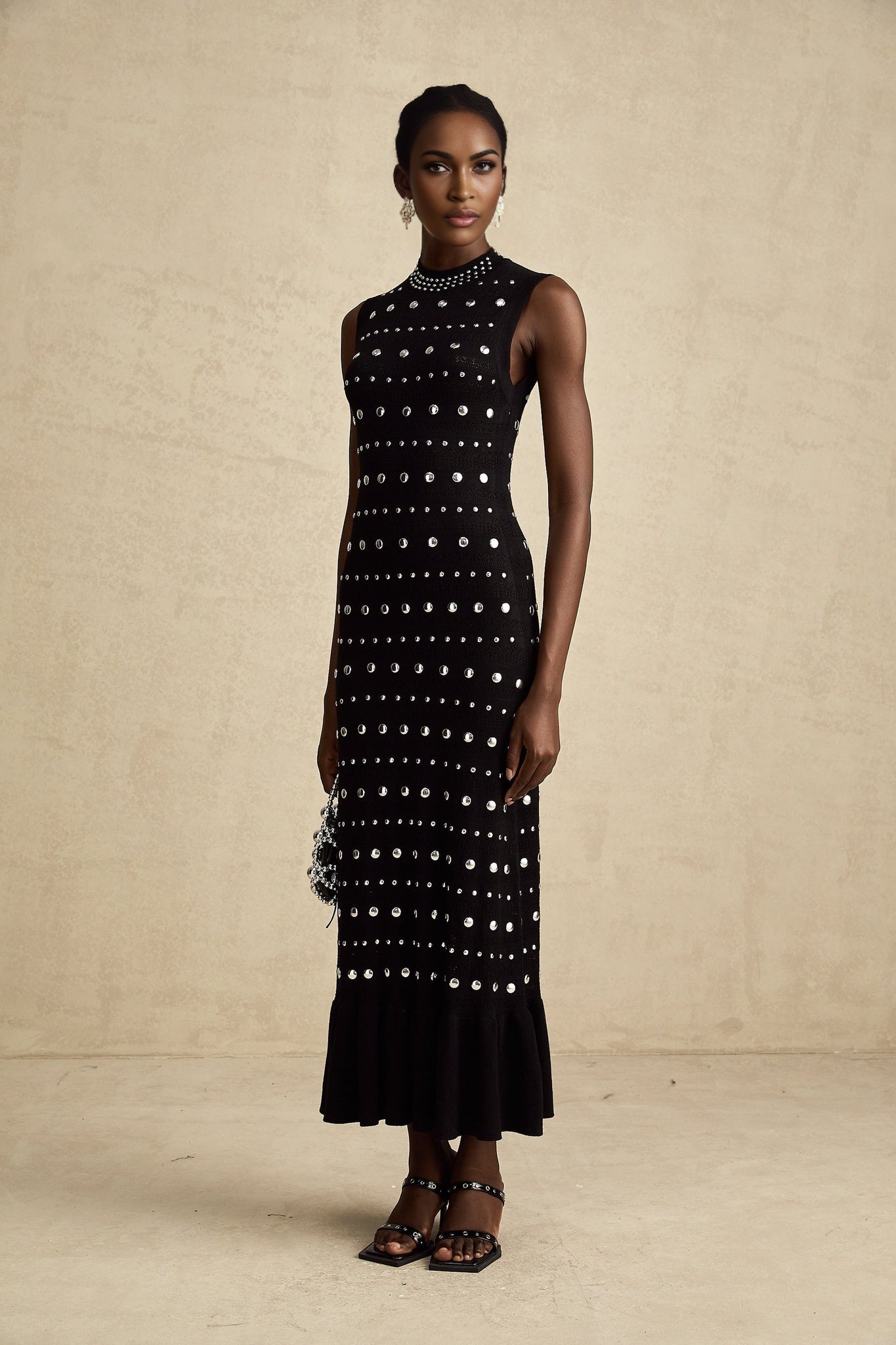 Long black maxi dress with crochet knit design and studded details by Chloe