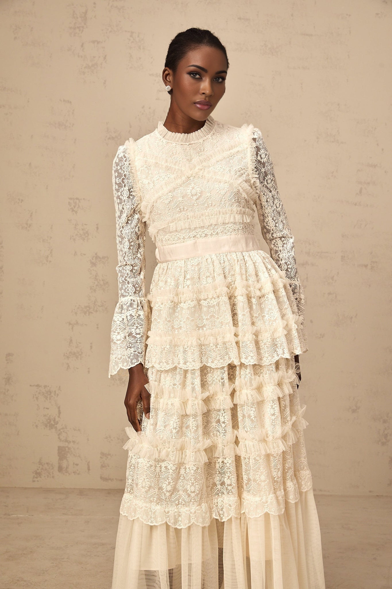 Long flowy maxi dress in neutral tones with lace panels and ruffled tulle details