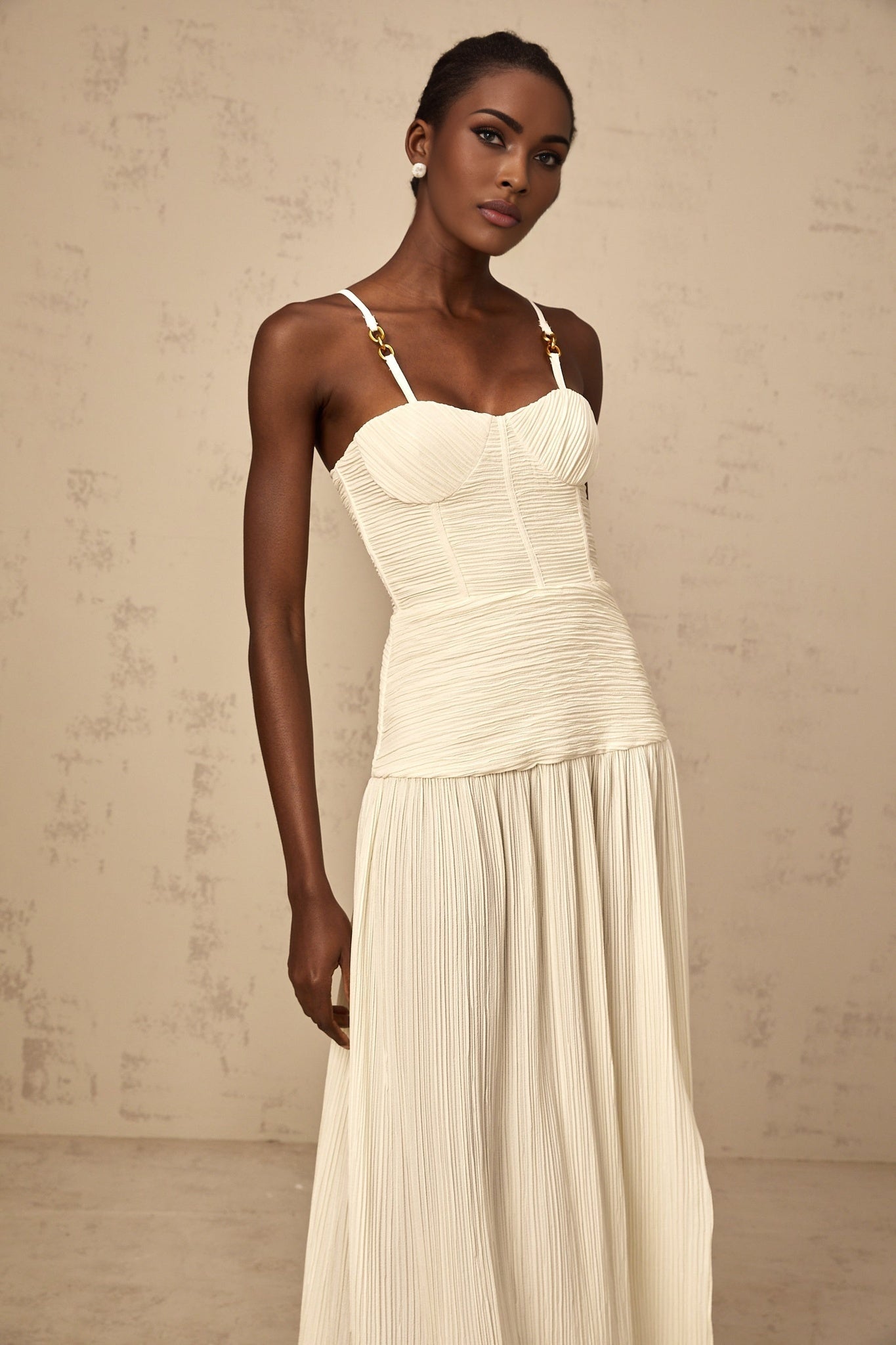 Long pleated maxi dress with side slit in neutral color tones