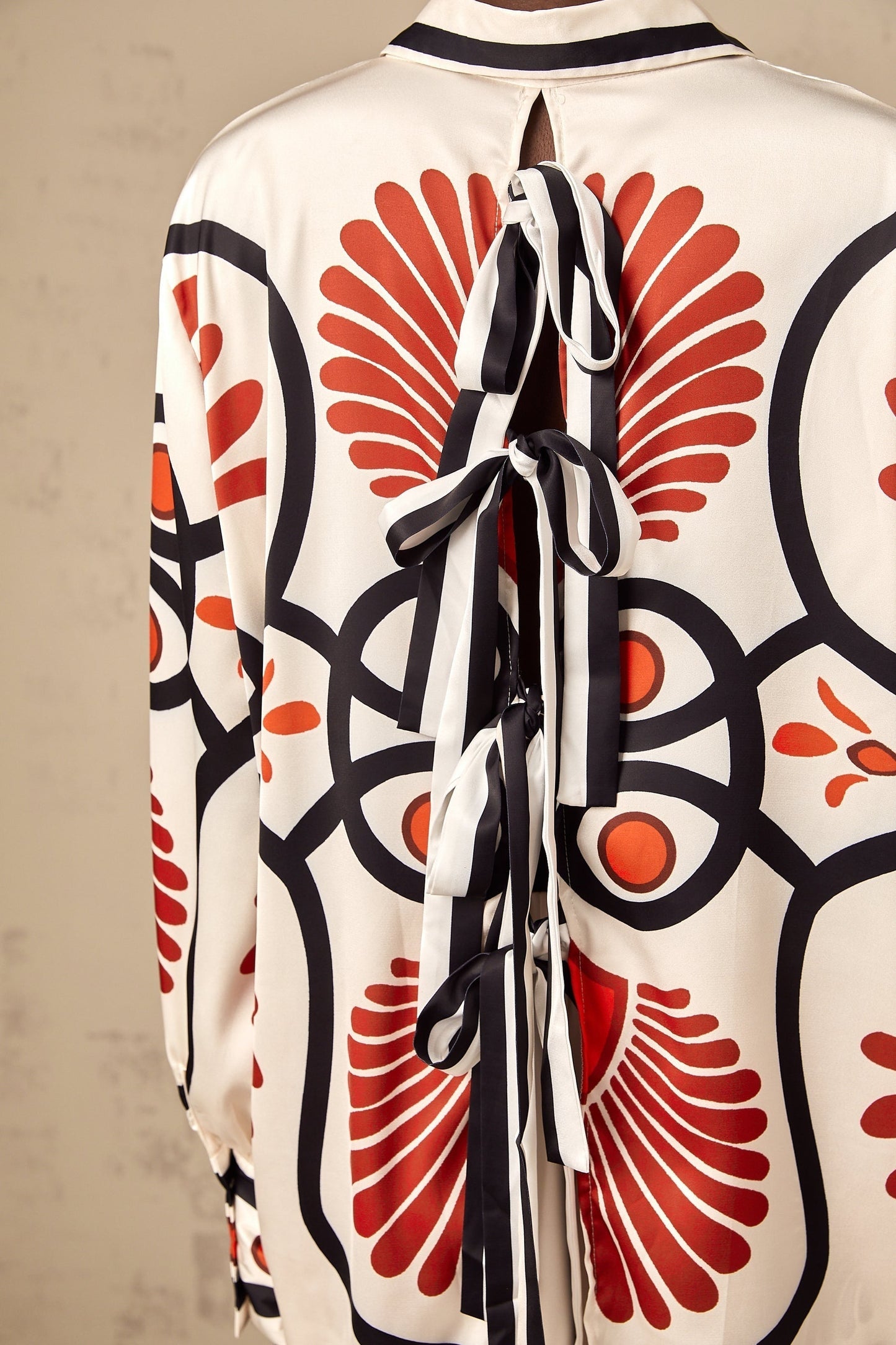 Matching set of Amaranta shirt and trousers with graphic print pattern