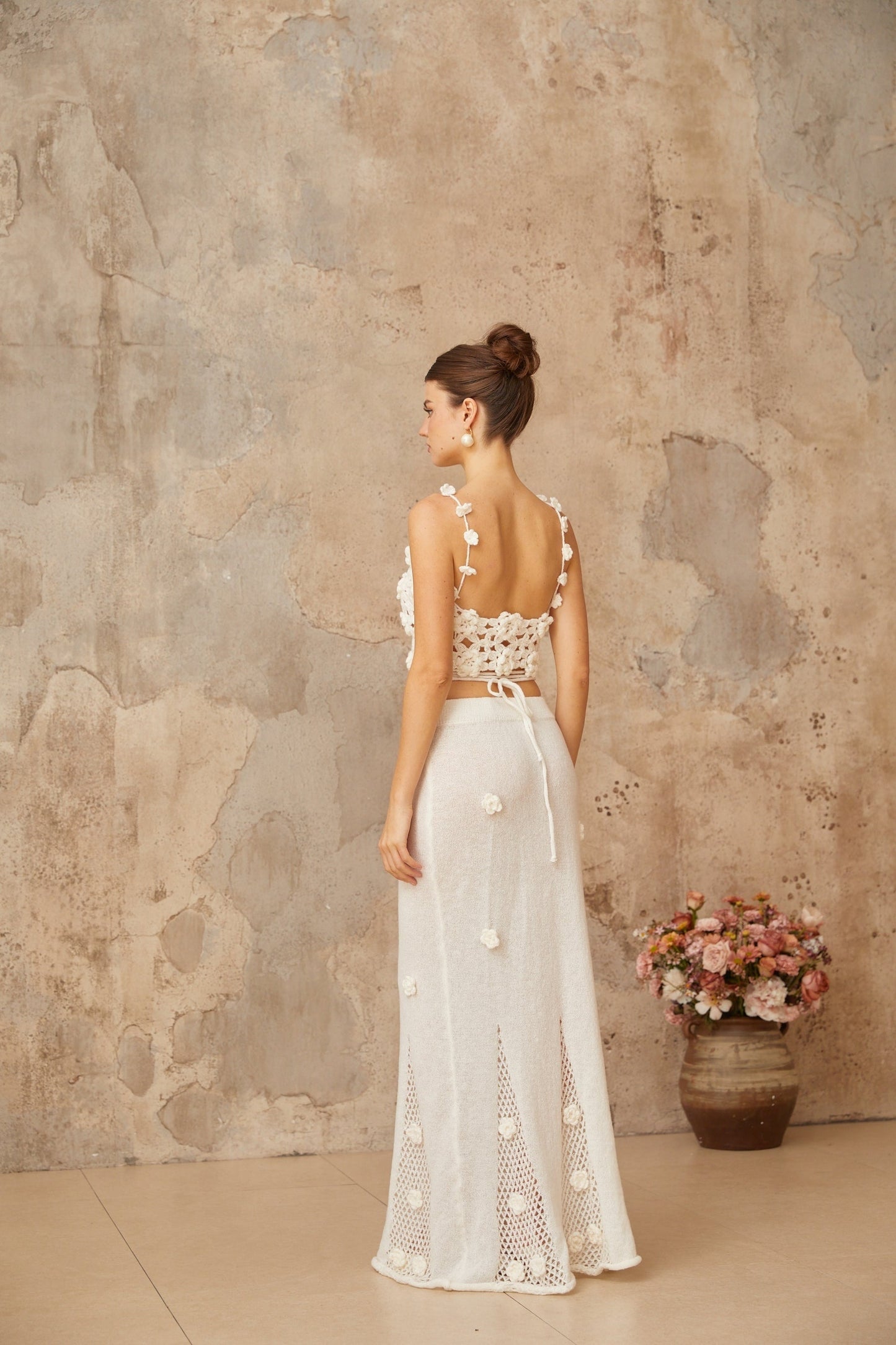 Matching white set featuring a top and skirt with floral applique detailing named Pauline