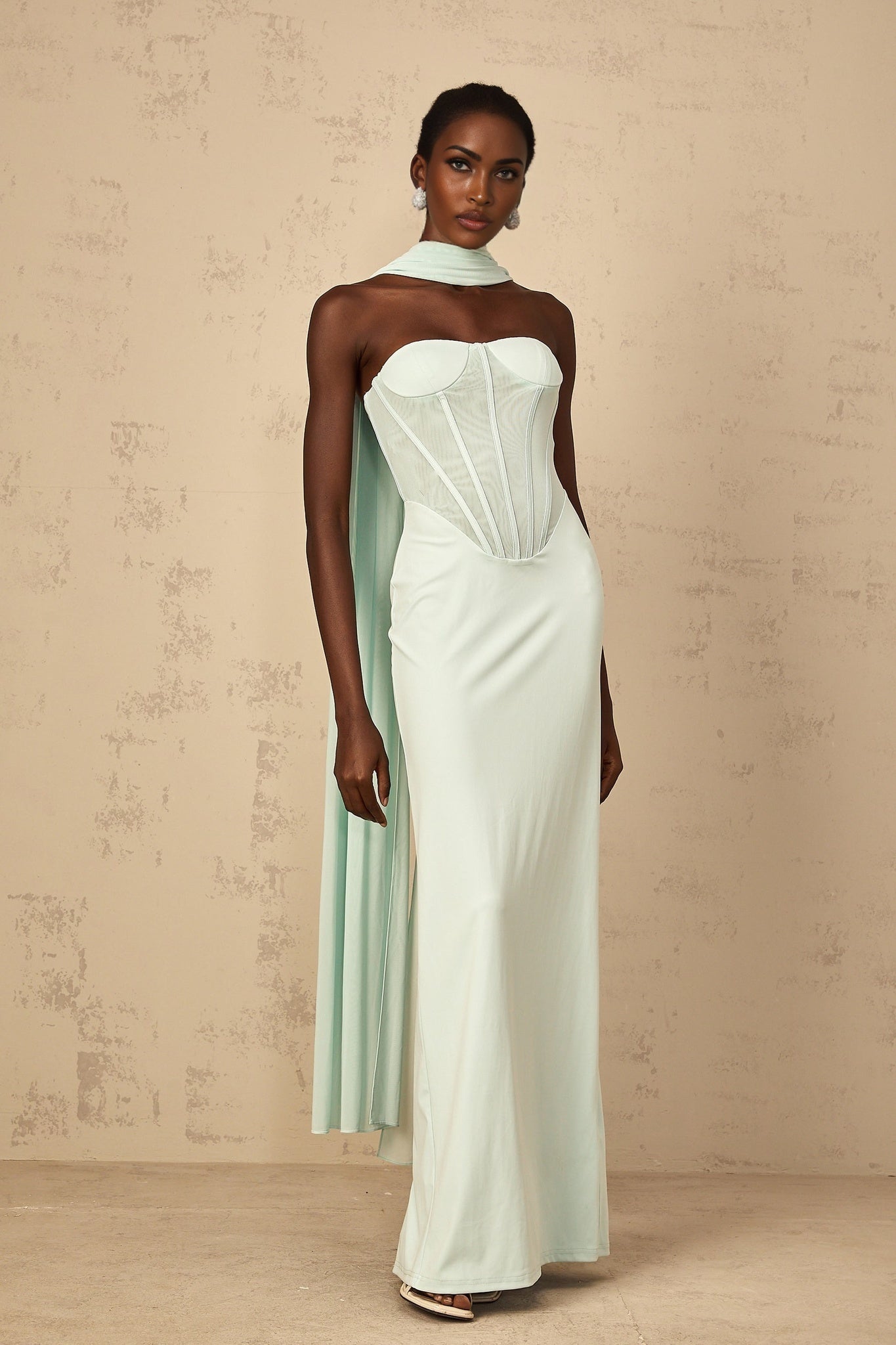 Mint green maxi dress with tulle panels and corset bodice featuring long flowy skirt and delicate shoulder straps