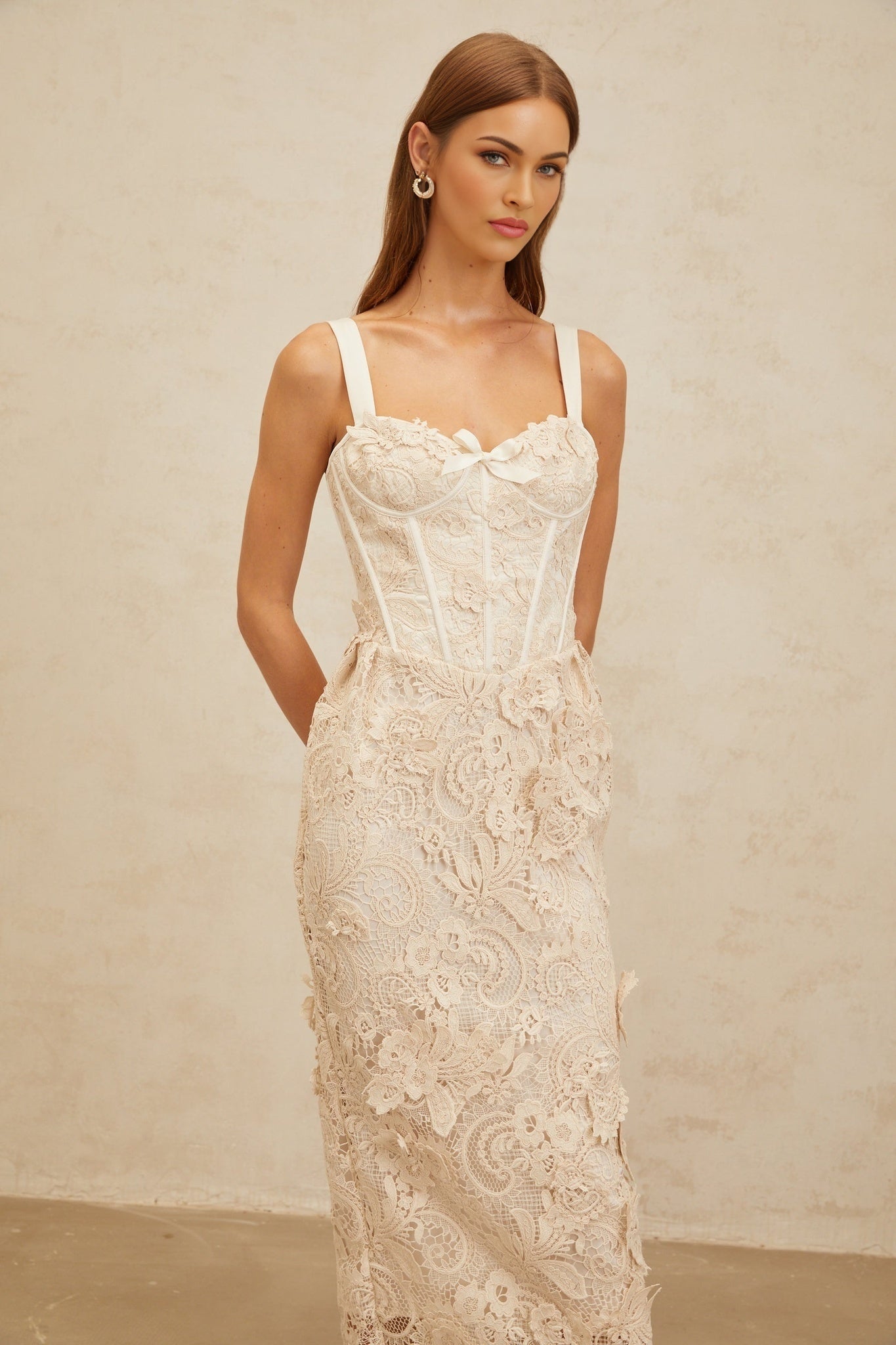 Neutrals sweetheart neckline corset style dress with bow embellishment and rear slit in midi length