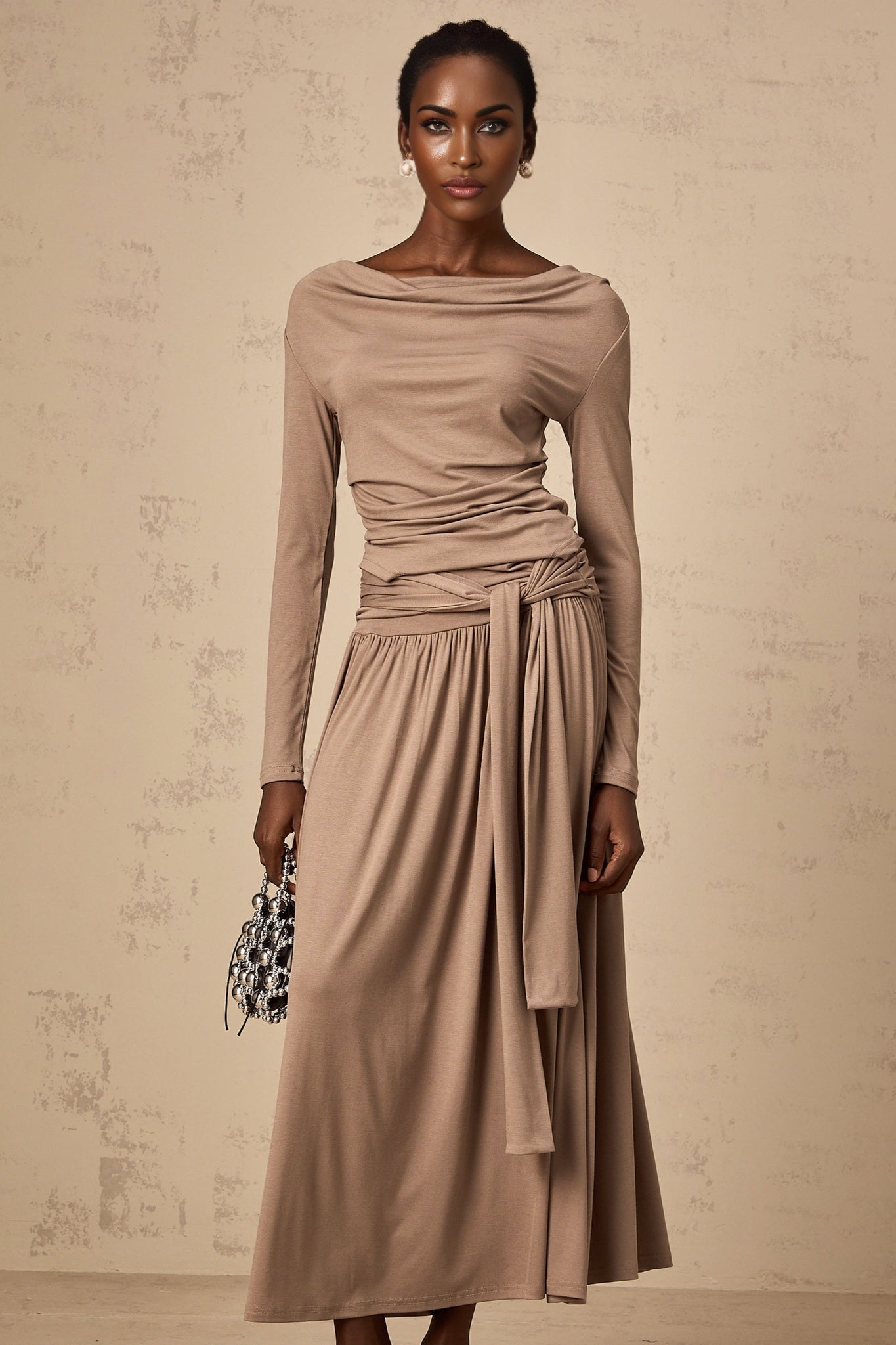 Oatmeal colored matching set featuring a draped top and skirt in stretchy fabric