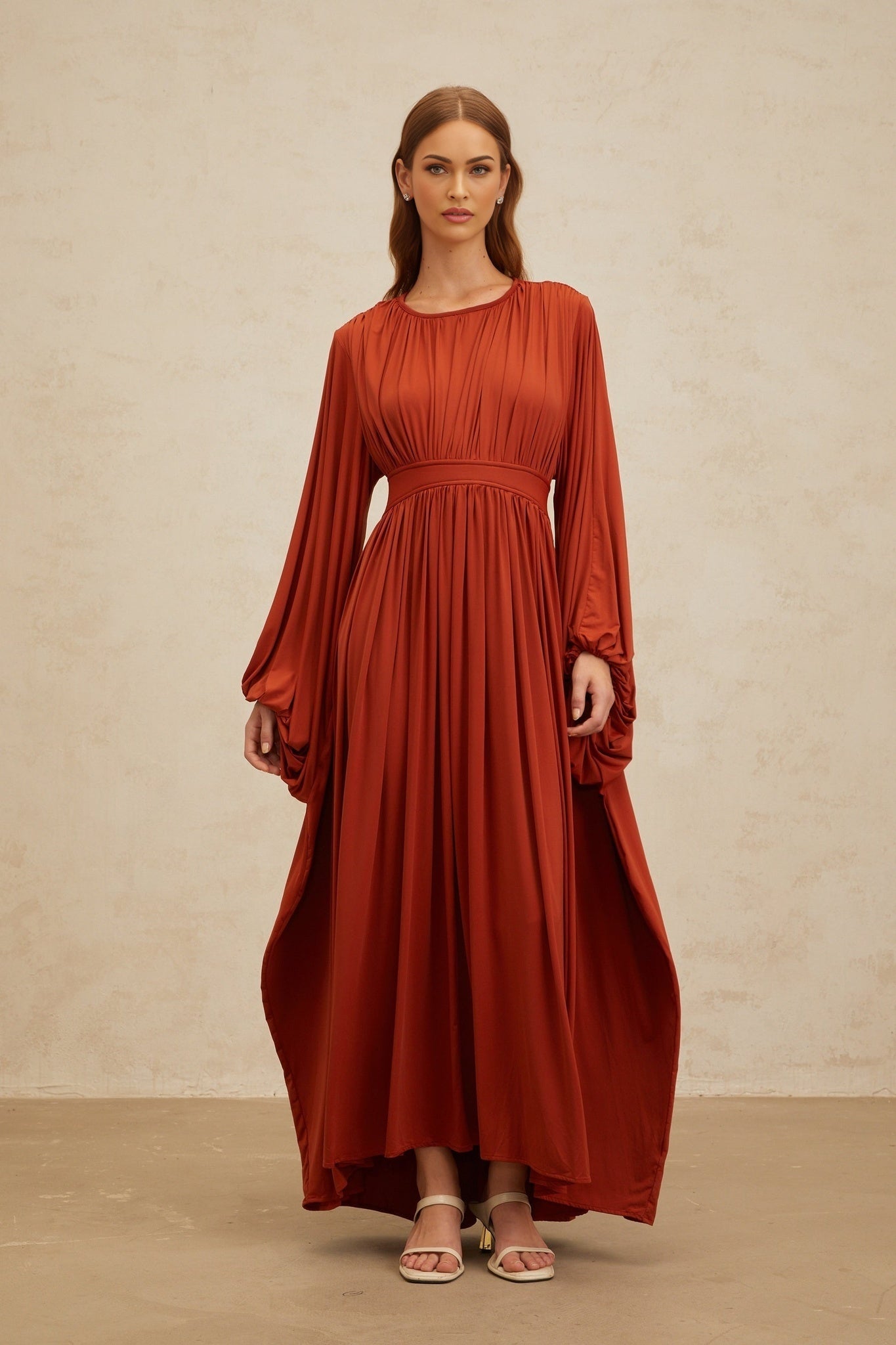 Orange long puff sleeve maxi dress with cinched waist and pleated detailing