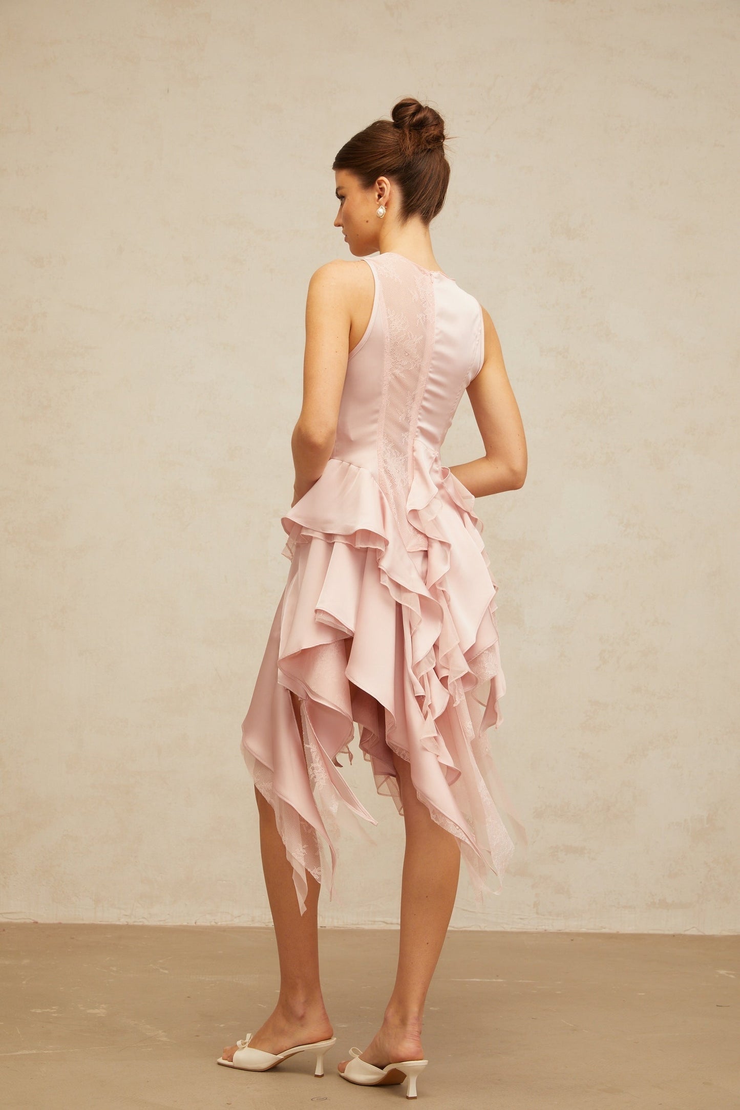 Pink asymmetrical ruffled top and matching skirt set named Calliopee featuring panelled design
