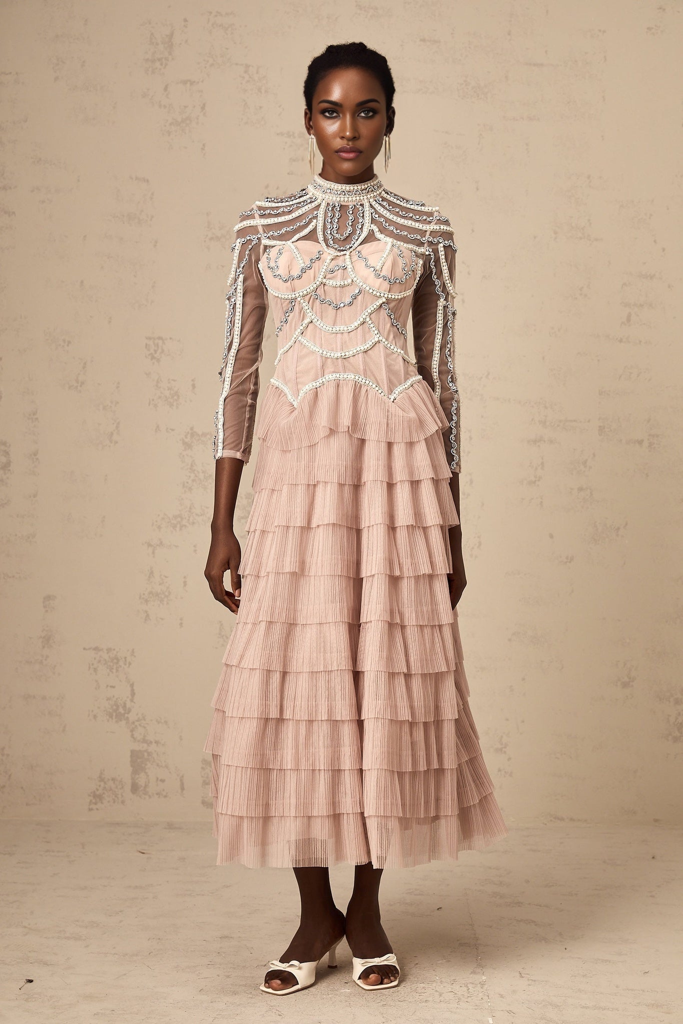 Pink beaded gown with tiered semi sheer design and floor length silhouette