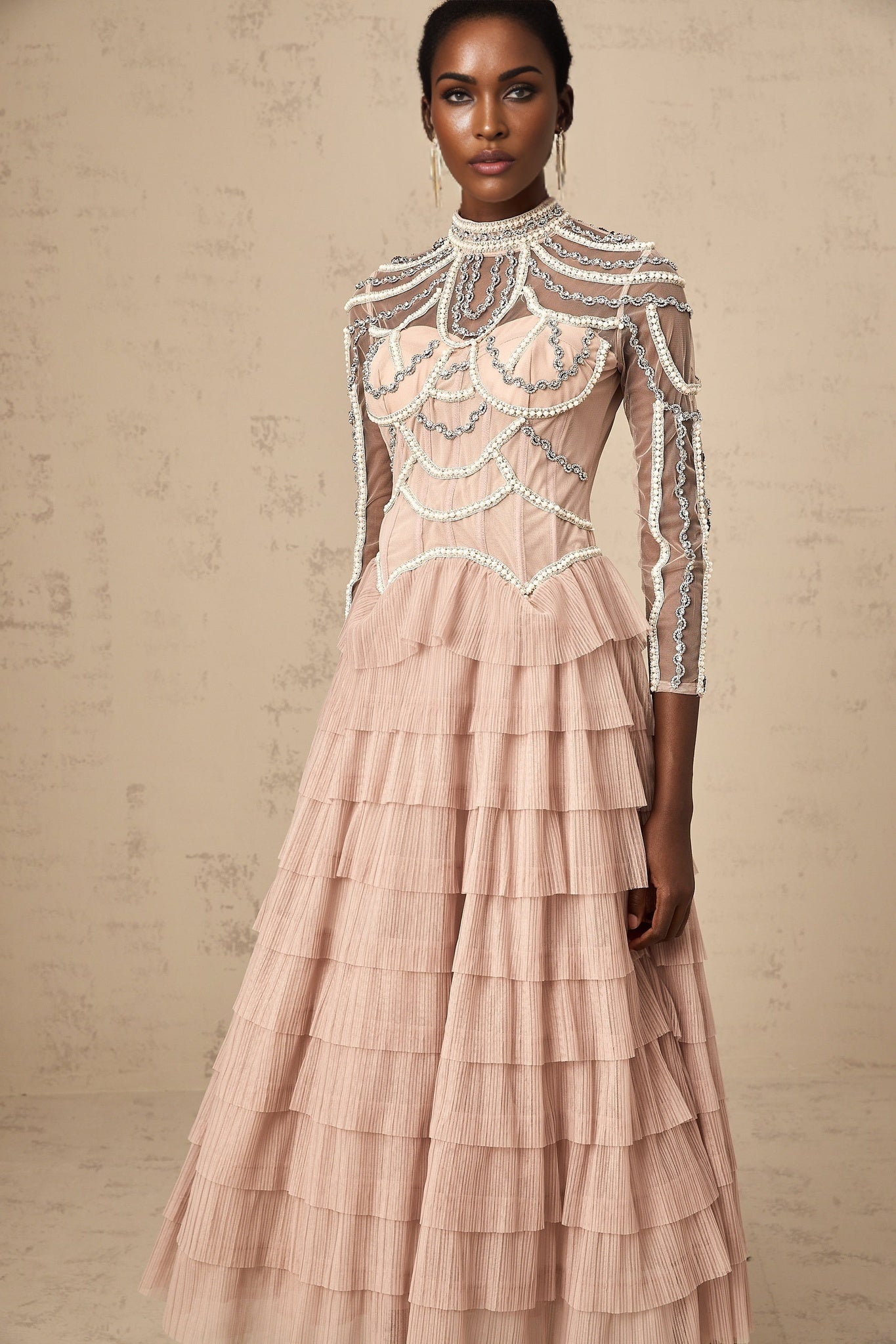 Pink beaded gown with tiered semi sheer skirt and long sleeves