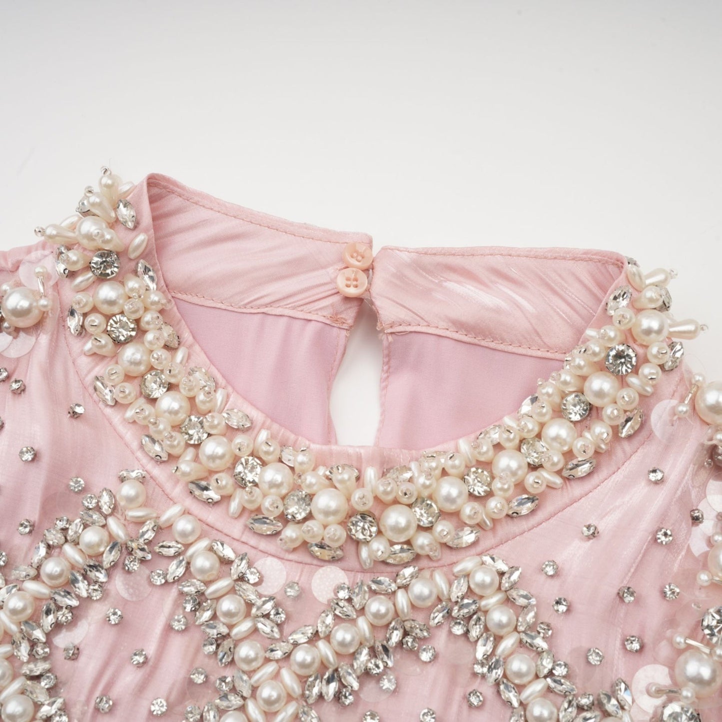 Pink mini dress with pleated skirt and embellished details named Helena