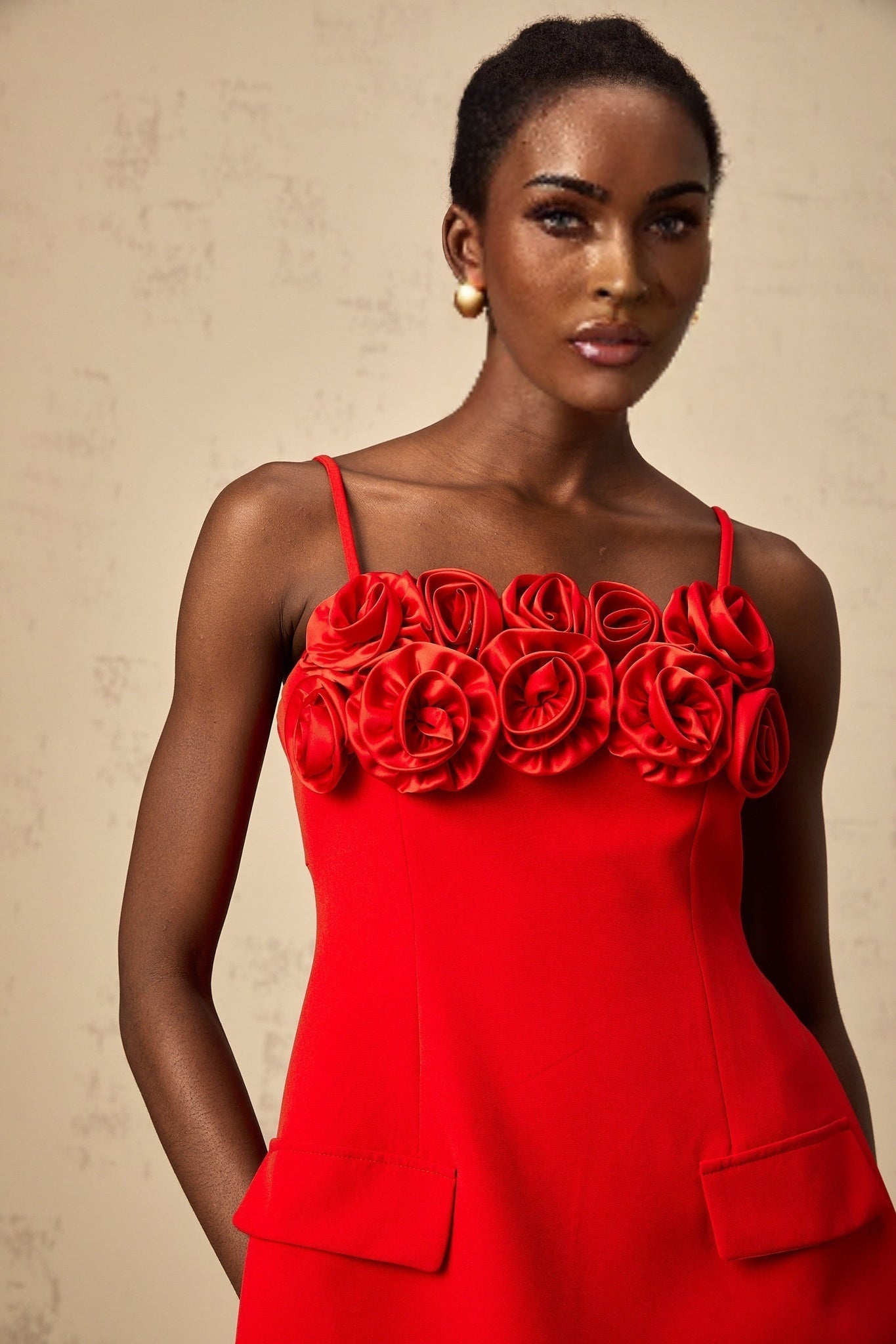 Red flared mini dress with rose applique details and a feminine silhouette