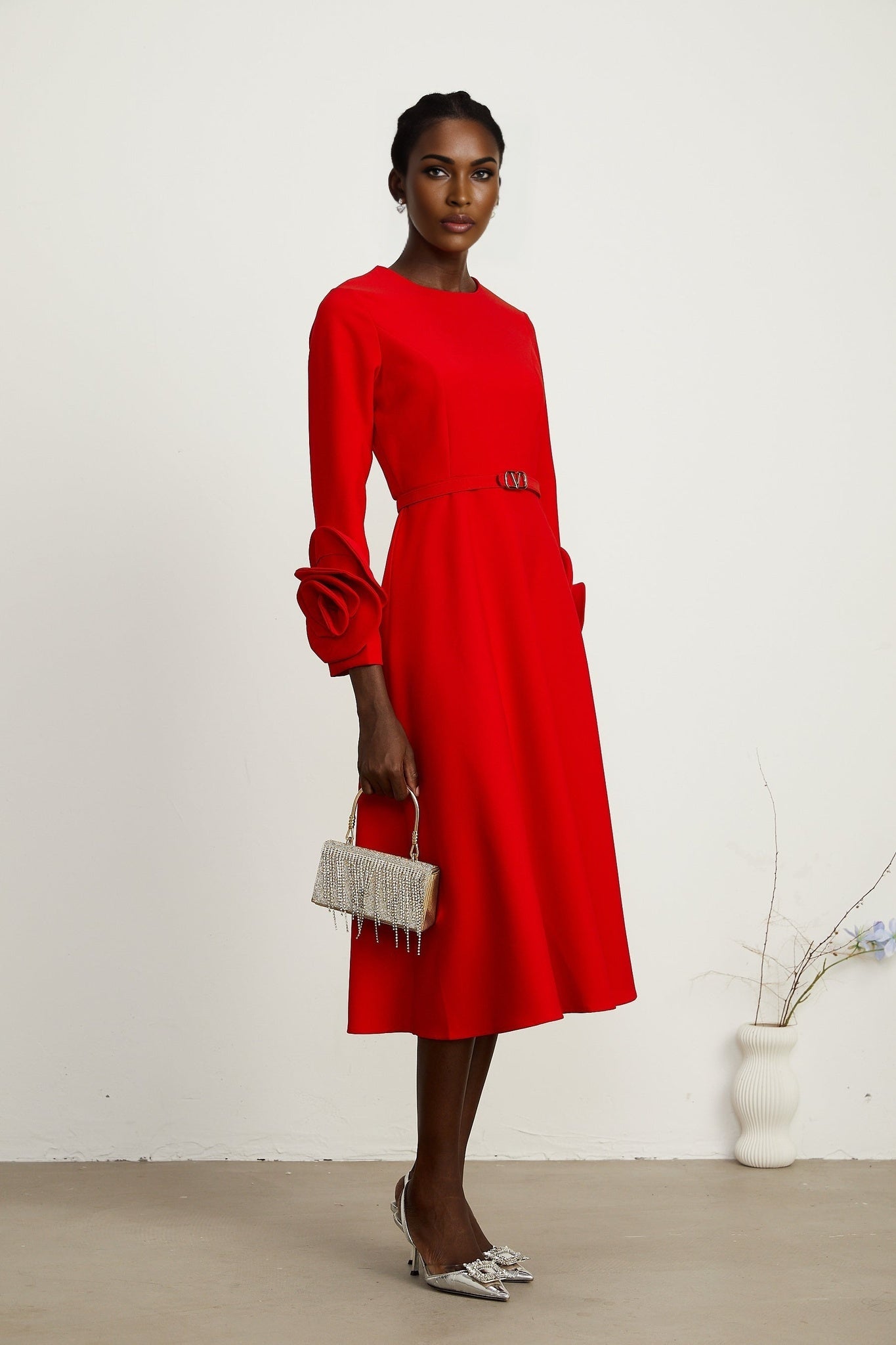 Red long sleeve dress with floral embellishments by Aurelia