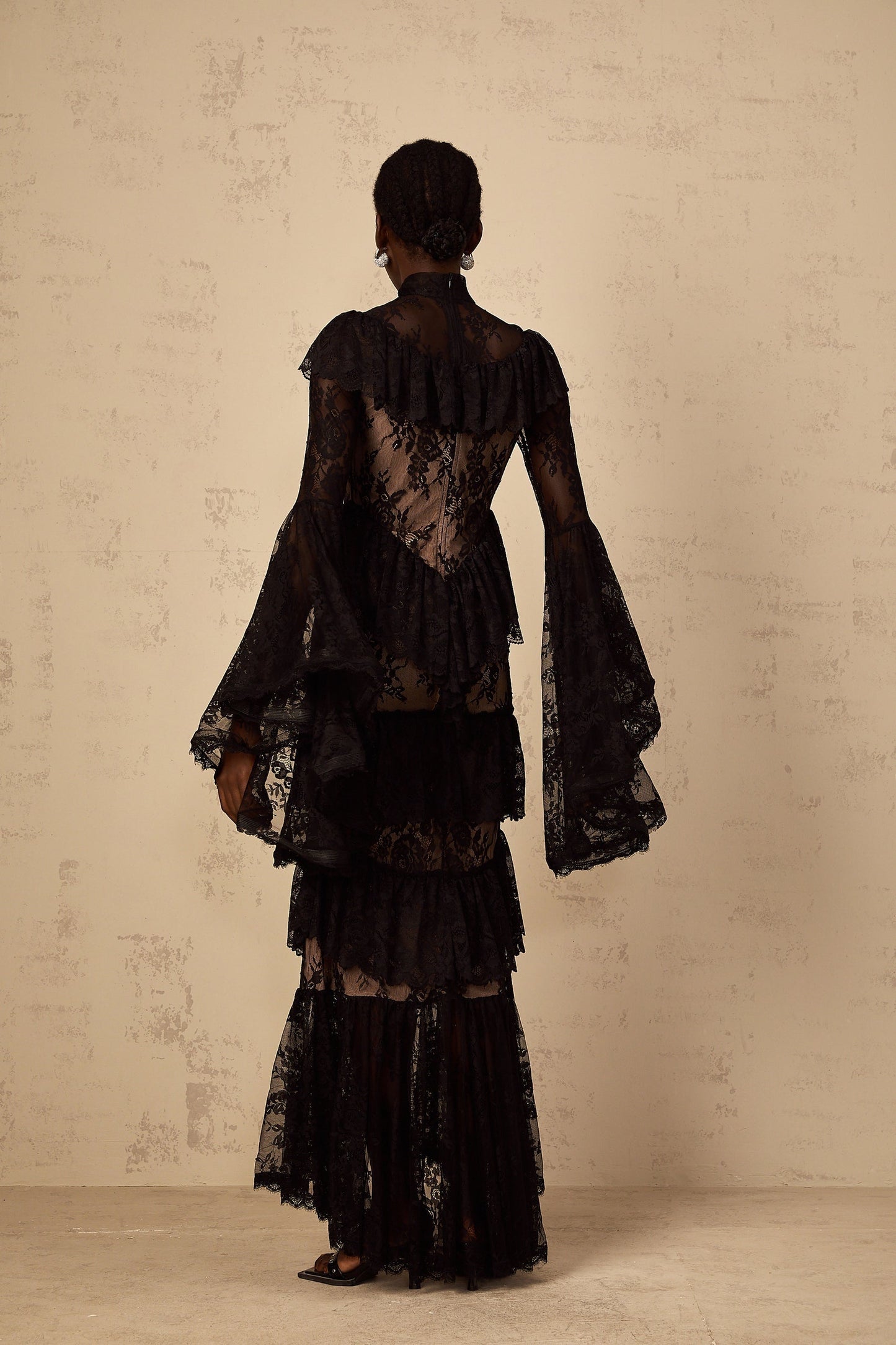 Roxane black maxi dress with floral lace pattern and ruffled details full length view on white background