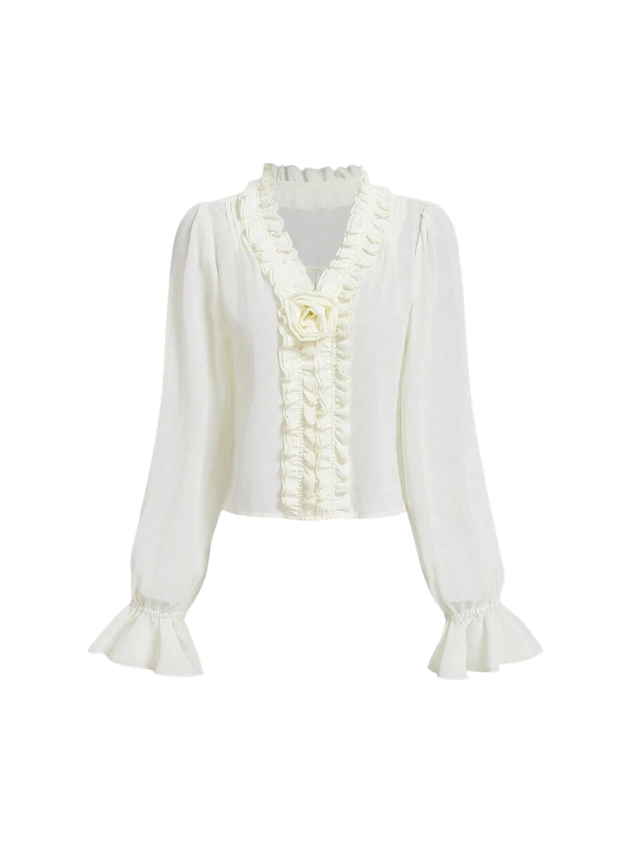 White chiffon blouse with ruffled details and flared sleeves