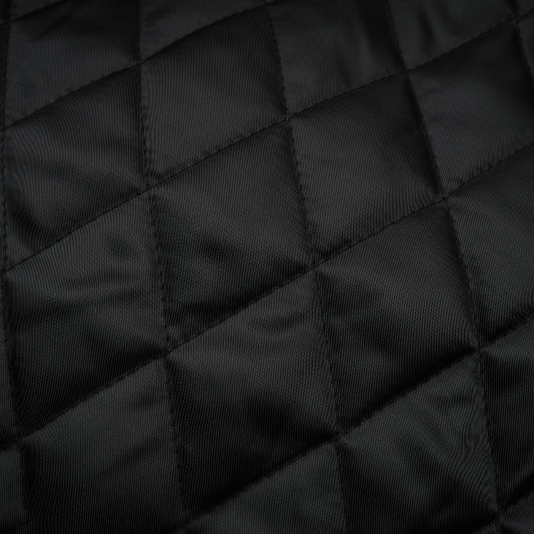 Short quilted leather jacket in brown color with zipper closure and stand collar