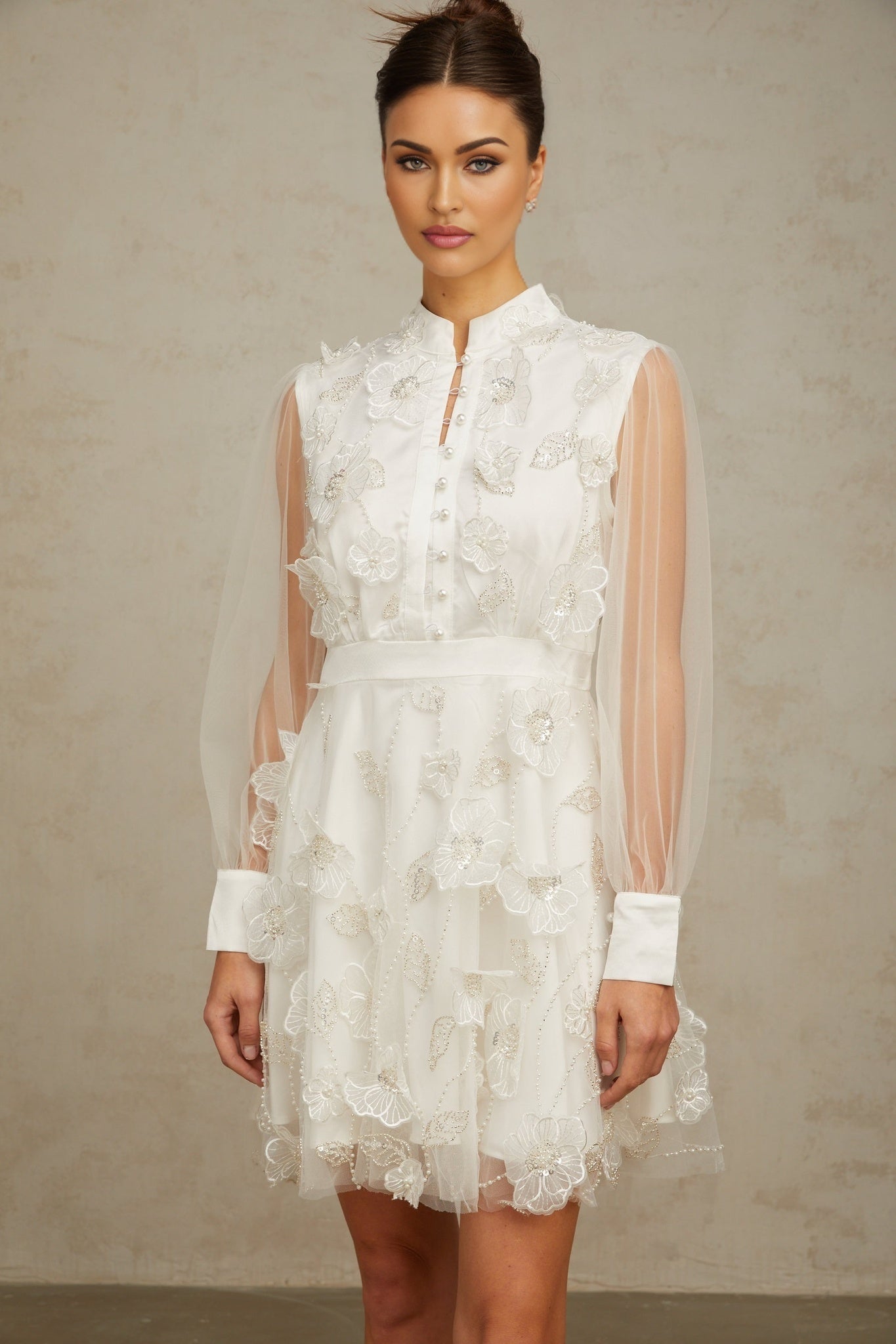 Short white mini dress with 3D floral tulle petals covering the bodice and skirt