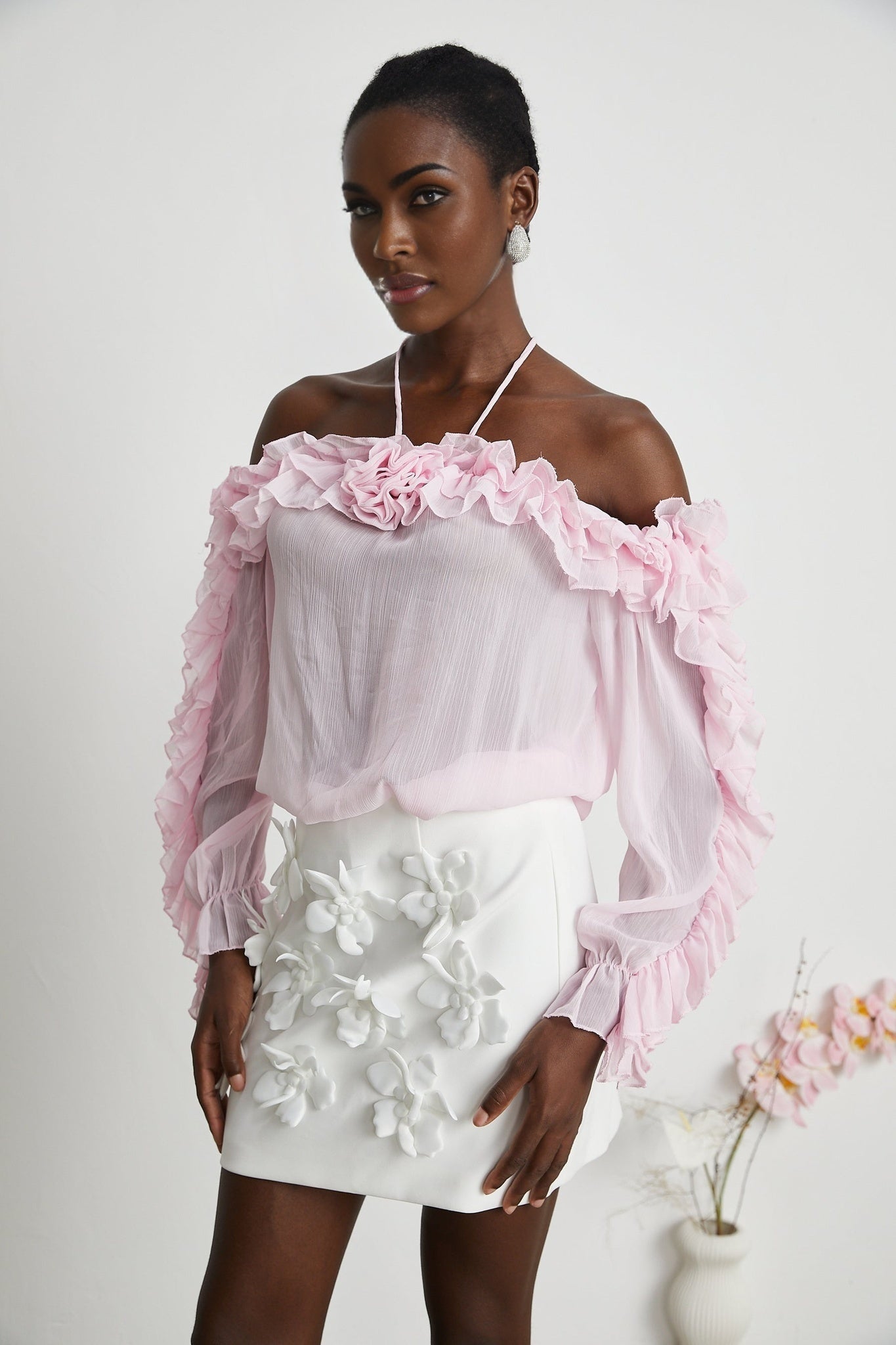 Sleeveless pink semi sheer top with a straight neckline