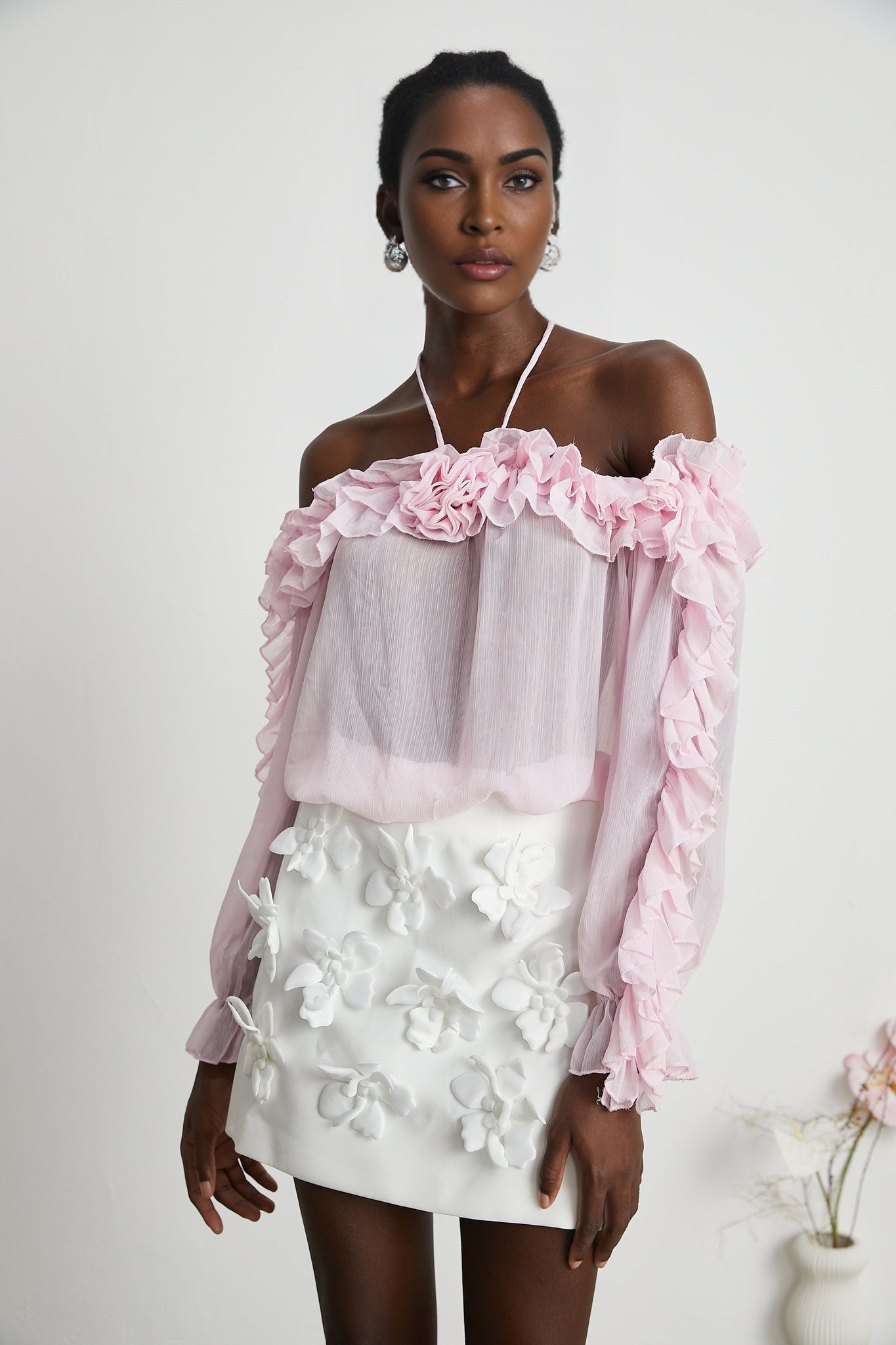 Sleeveless sheer pink top called Darcy with straight neckline and semi transparent fabric