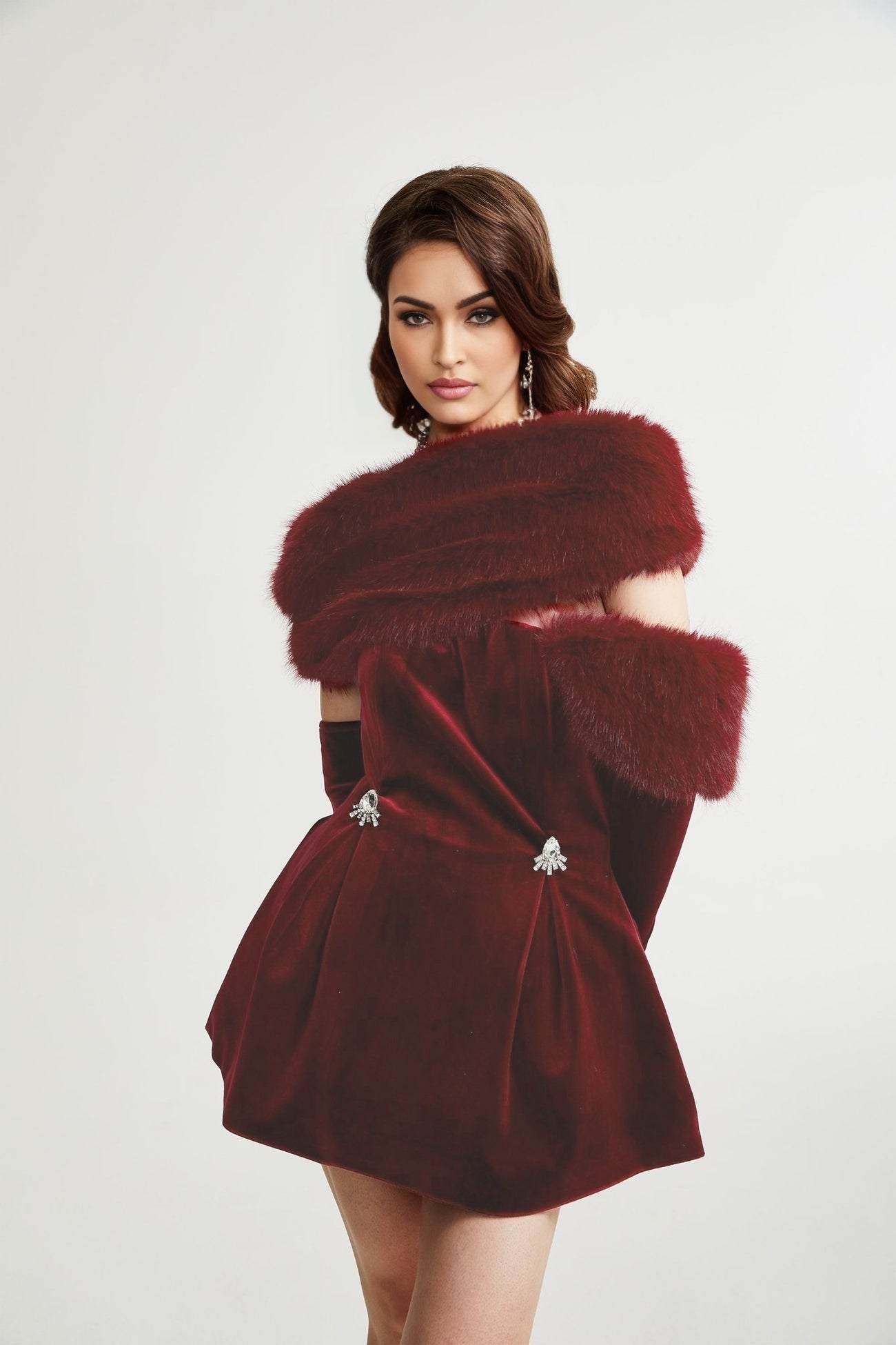 Strapless black velvet mini dress with white faux fur trim along neckline and hem