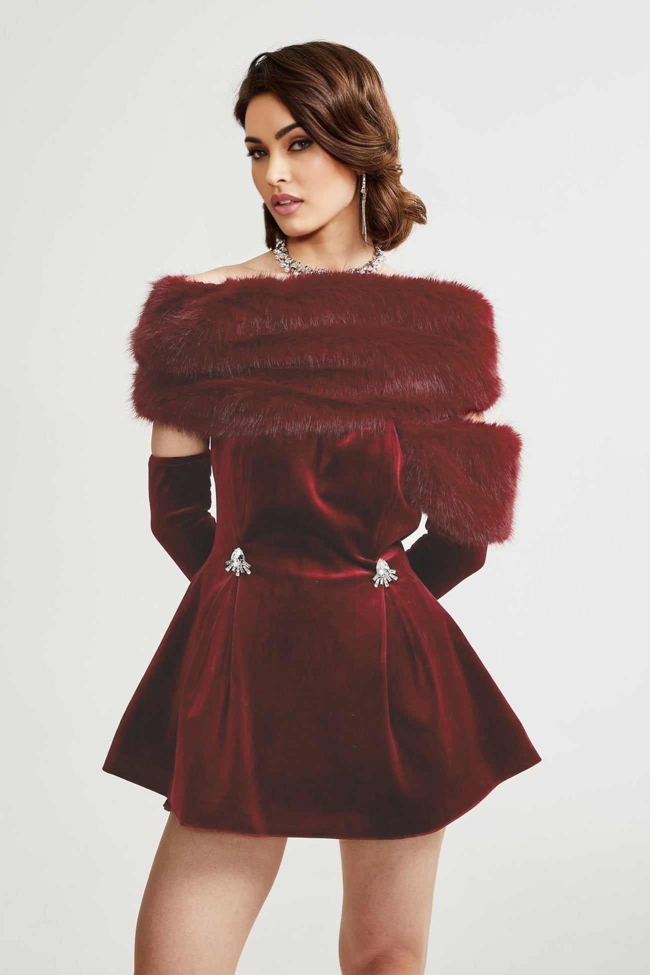 Strapless black velvet mini dress with white faux fur trim at top and bottom