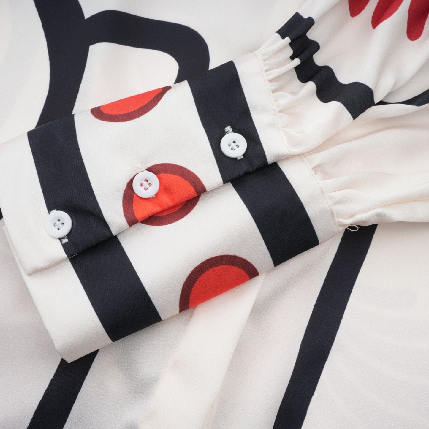 Stylish matching set featuring a graphicprint shirt and trousers in Amaranta design worn by a model