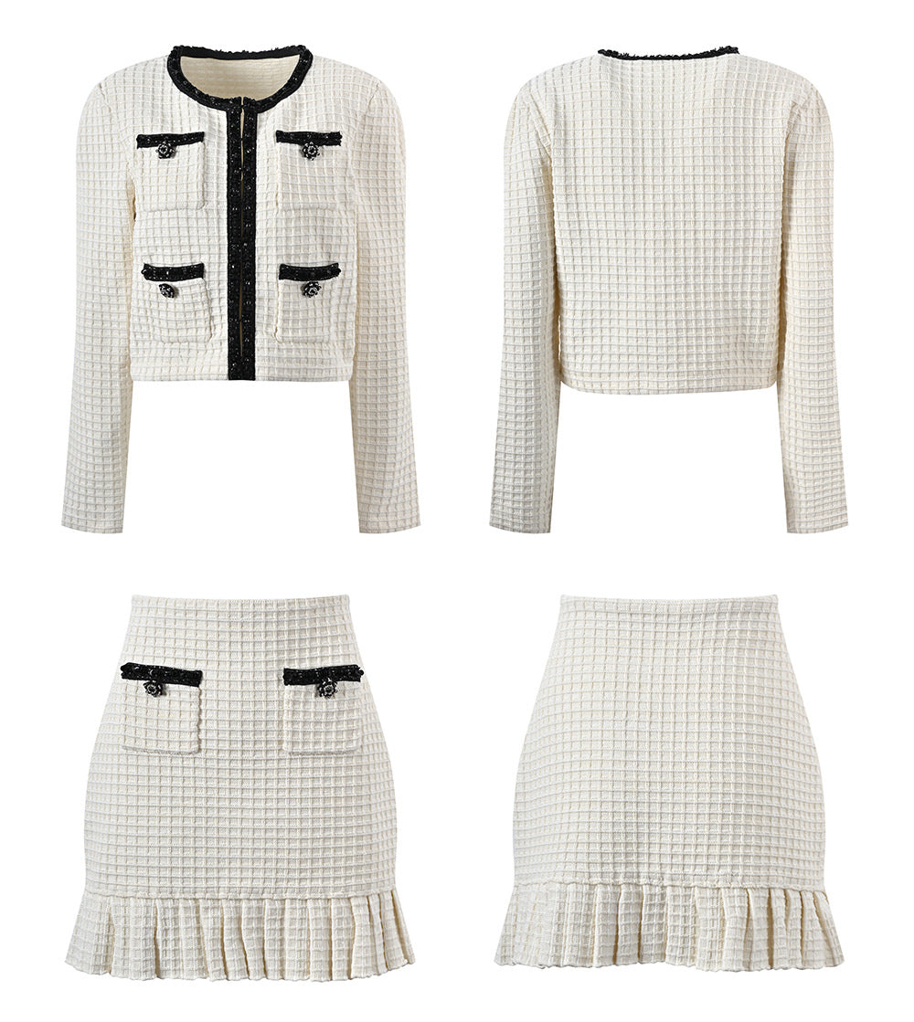 Textured white knitted jacket with black trim and decorative buttons paired with a ruffled hem skirt