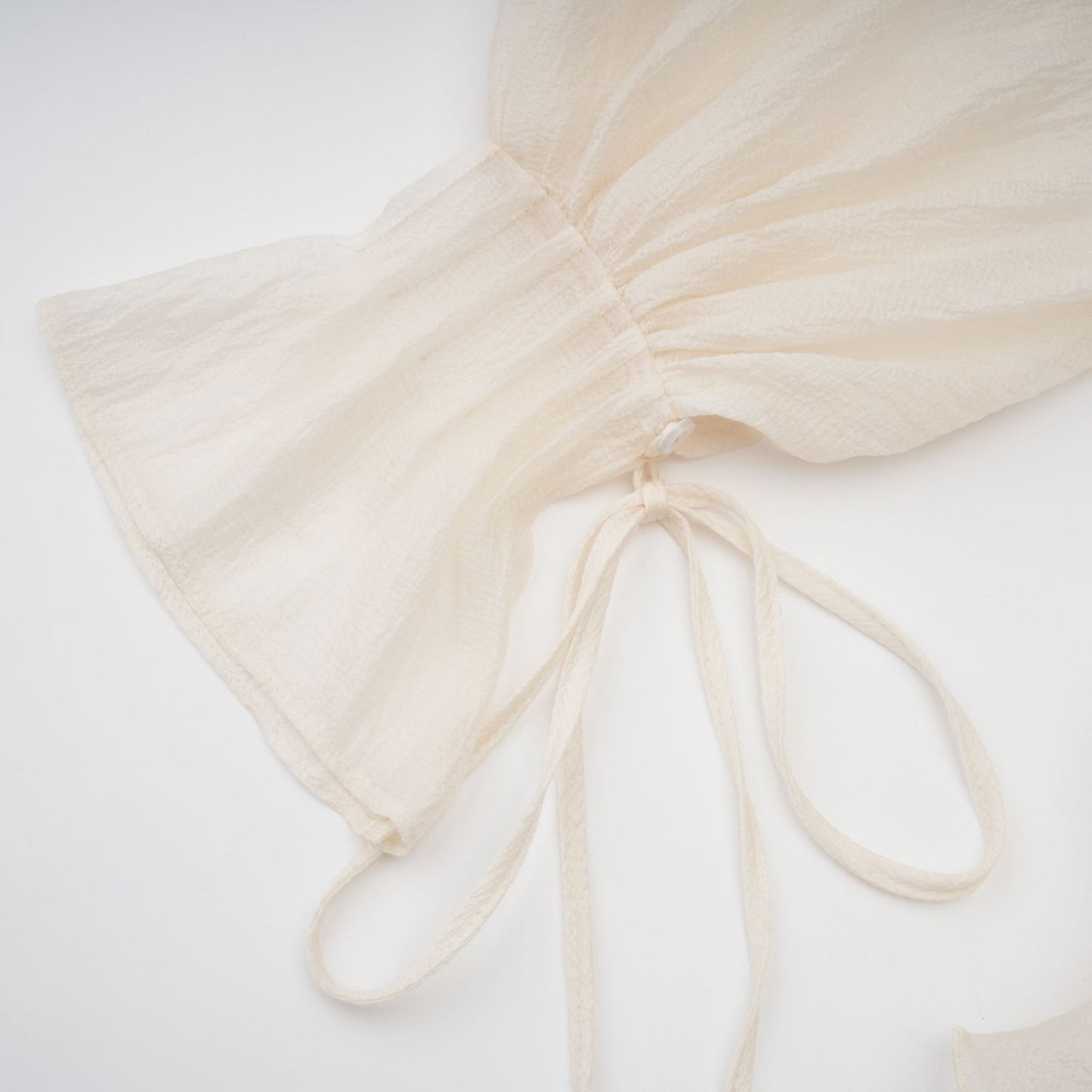 Tiered mini dress in neutral tones with floral applique details called Zephyrine