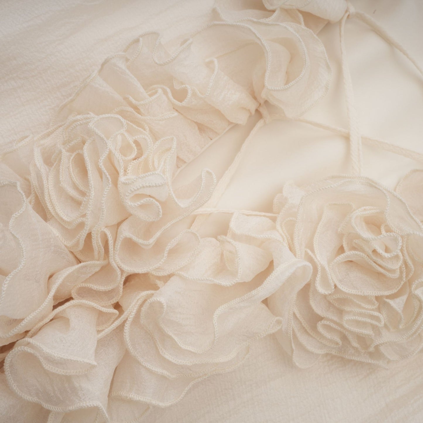 Tiered mini dress in neutral tones with floral applique details named Zephyrine