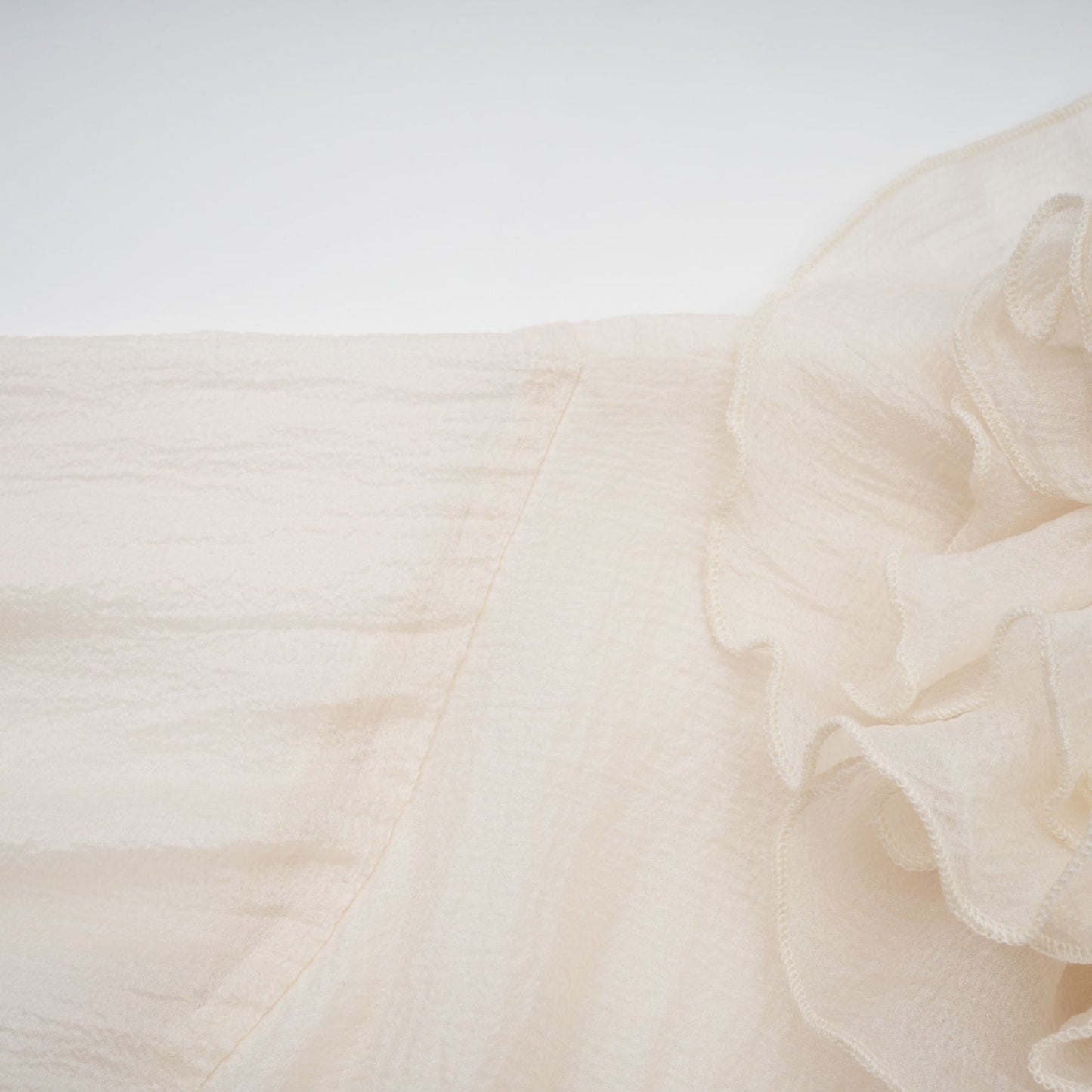 Tiered mini dress with floral applique details in neutral tones