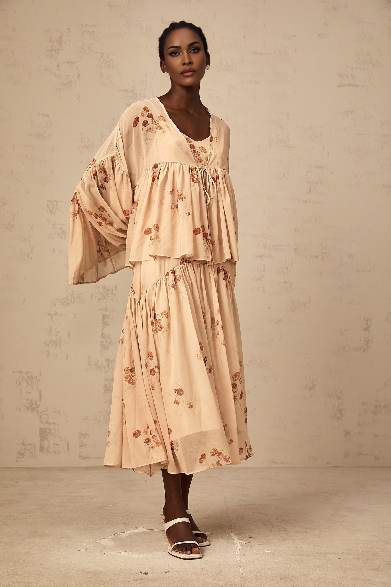 Two piece floral outfit with coral pink blouse and matching dress featuring pleated details and allover floral print