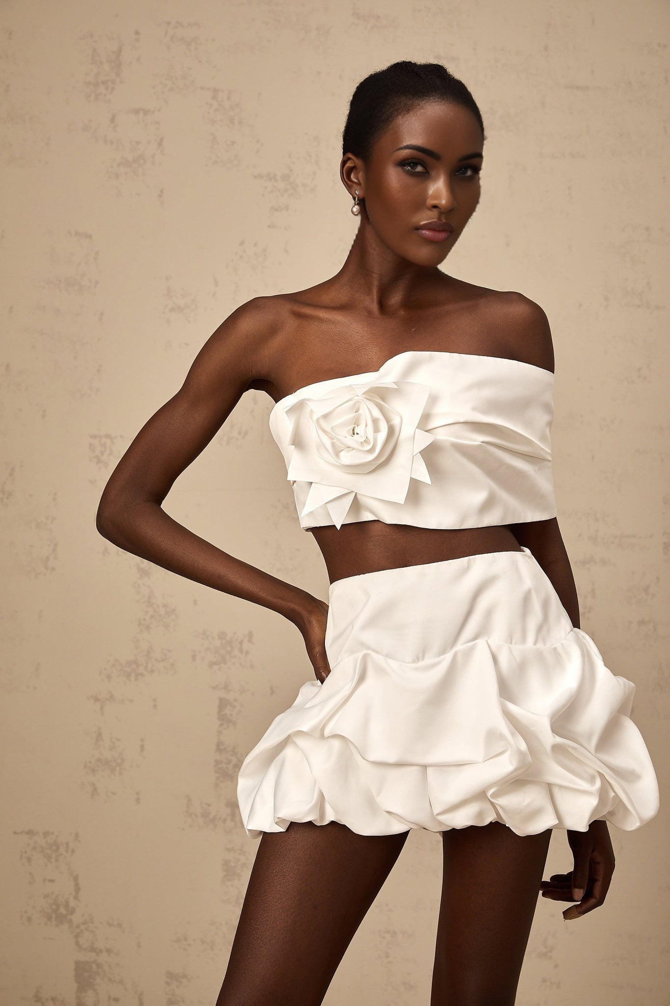 Two piece white outfit with floral pattern featuring a pleated top and matching skirt