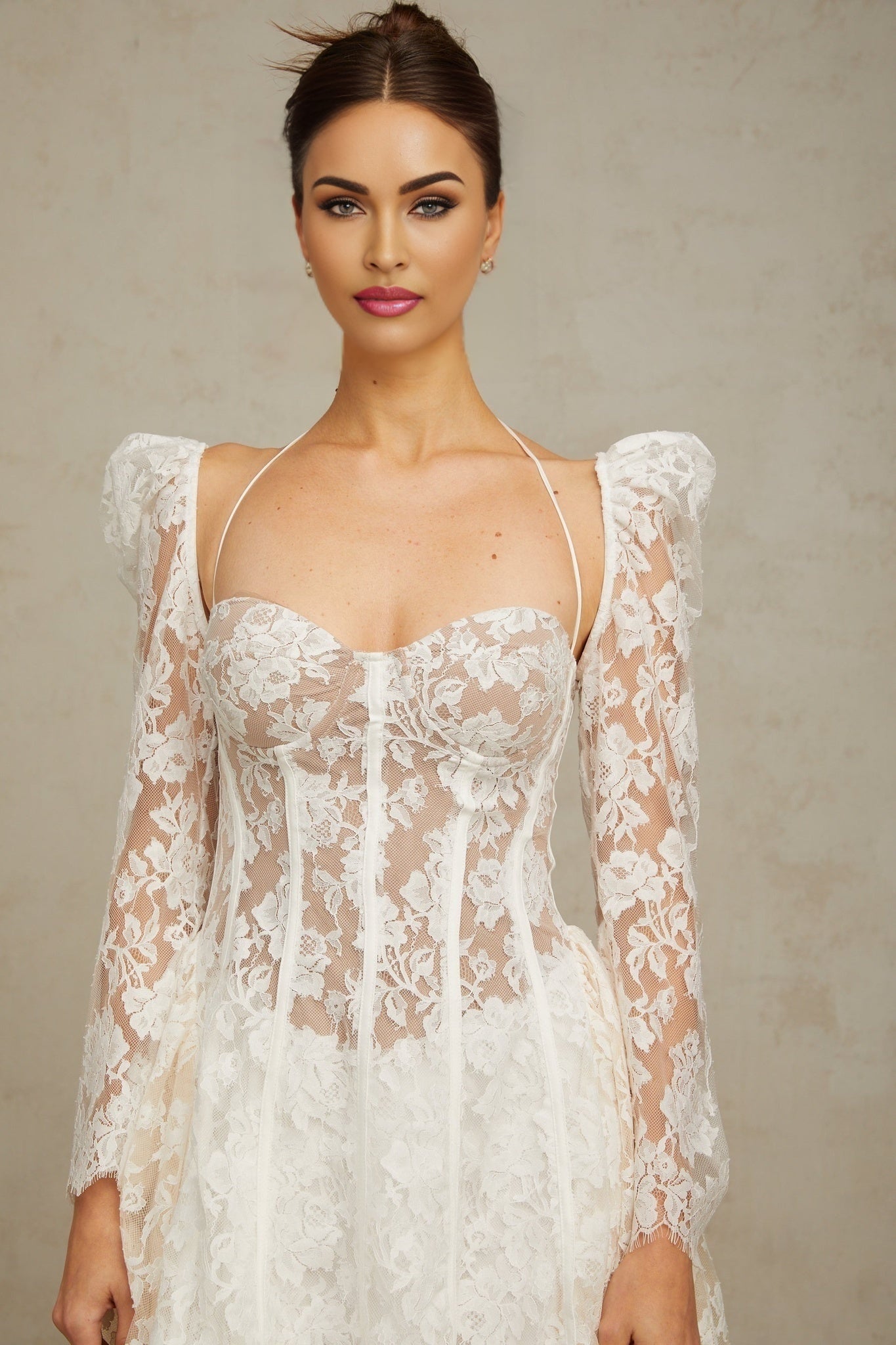Vivienne white mini dress with floral lace detailing and corset style bodice on a plain background