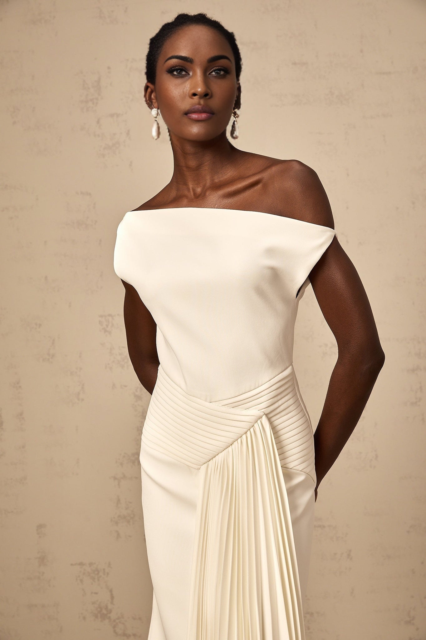 White asymmetric draped midi dress with a flowy design and uneven hemline