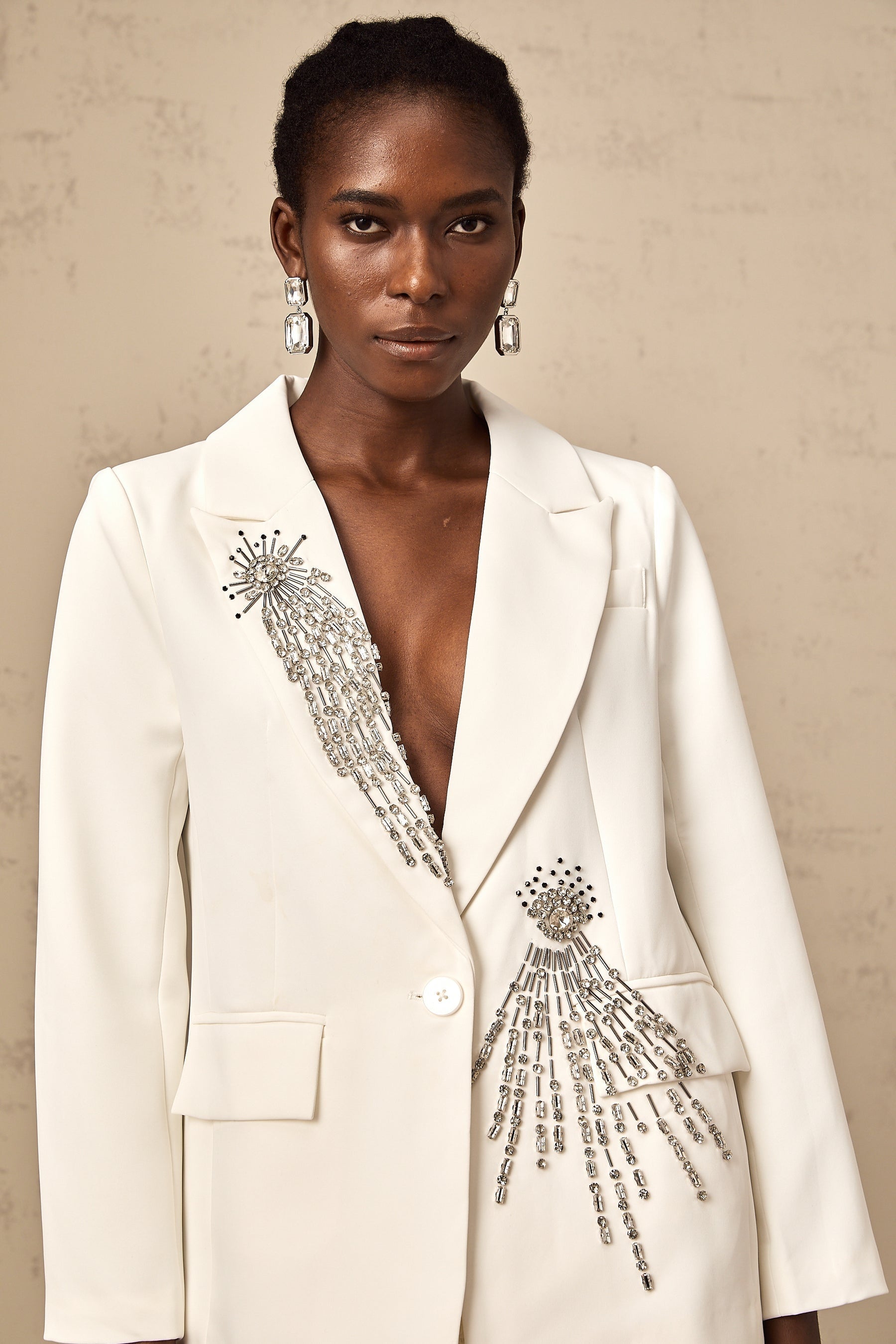 White blazer with crystal embellishments on a woman
