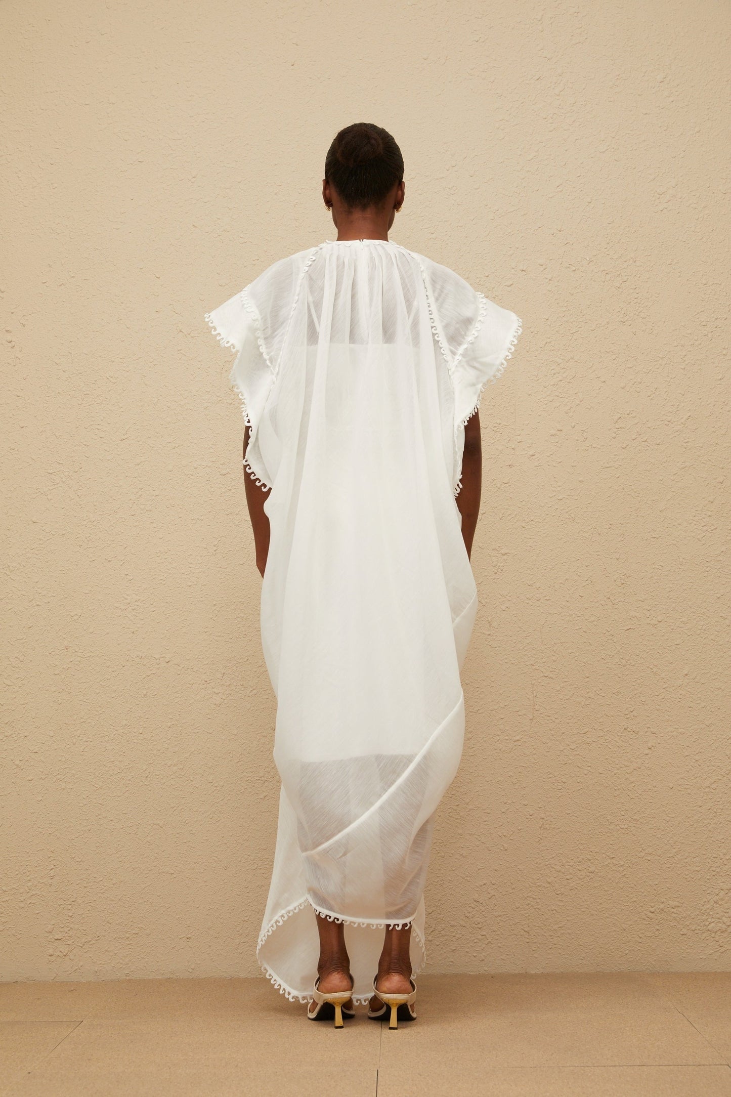 White cotton maxi dress with floral embroidery and cut-out detailing