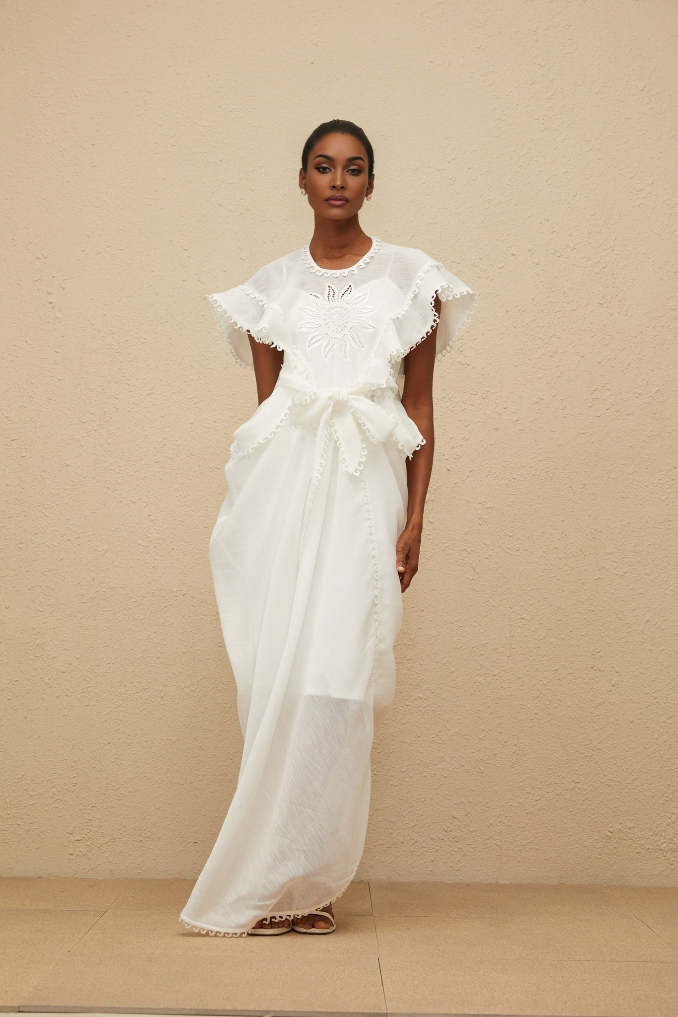 White cotton maxi dress with floral embroidery and cut-out detailing