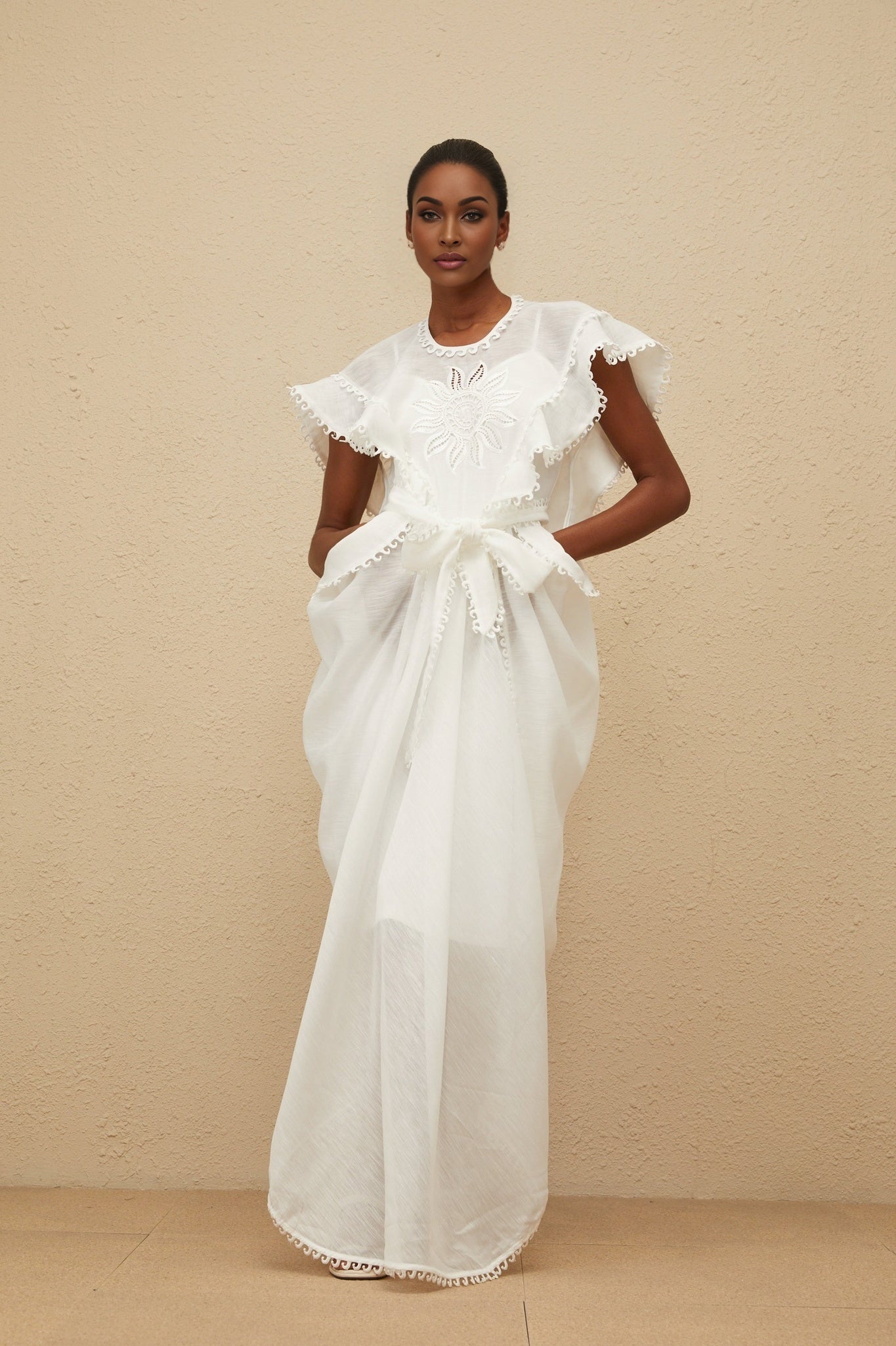 White cotton maxi dress with floral embroidery and tied waist