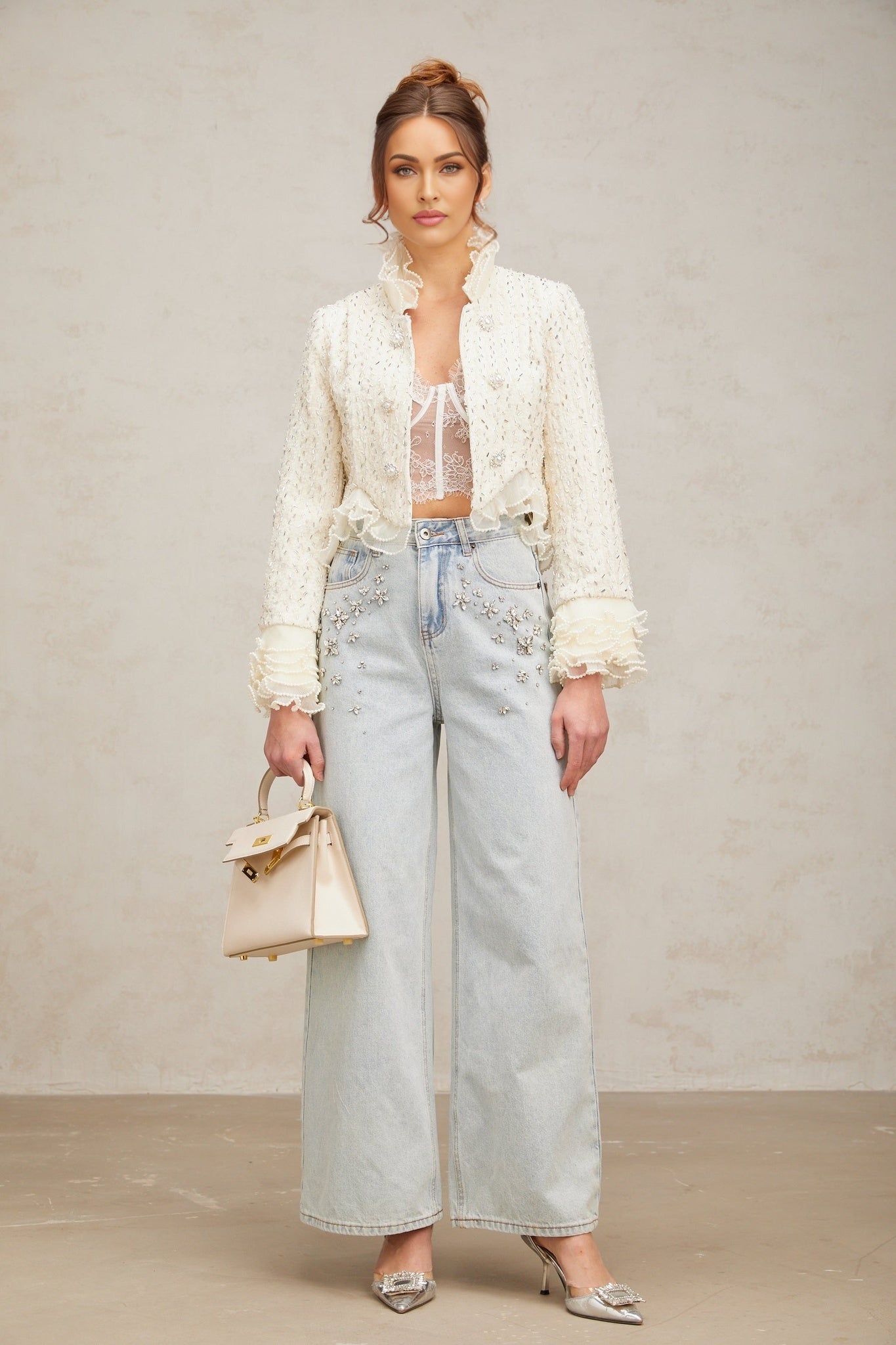 White cropped jacket with beaded details and ruffle trim