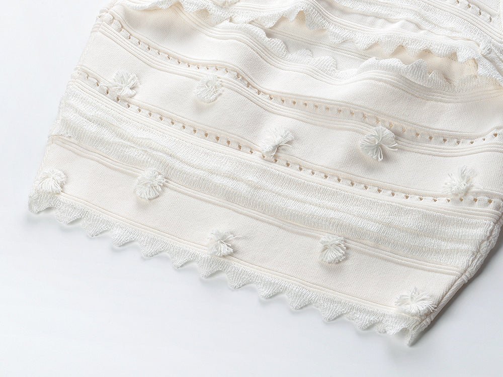 White embroidered sleeveless top and high-waisted skirt